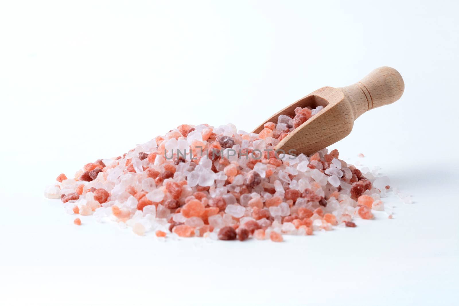 Wooden Spice Spoon In a Pile of Himalaya Salt Isolated on White Background