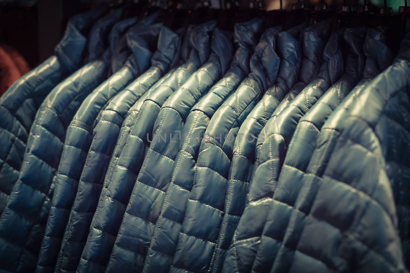 Filtered tone row of women down jackets at American outdoor clot by trongnguyen