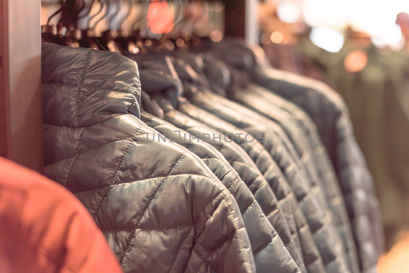 Row of women down jackets at American outdoor clothing store by trongnguyen