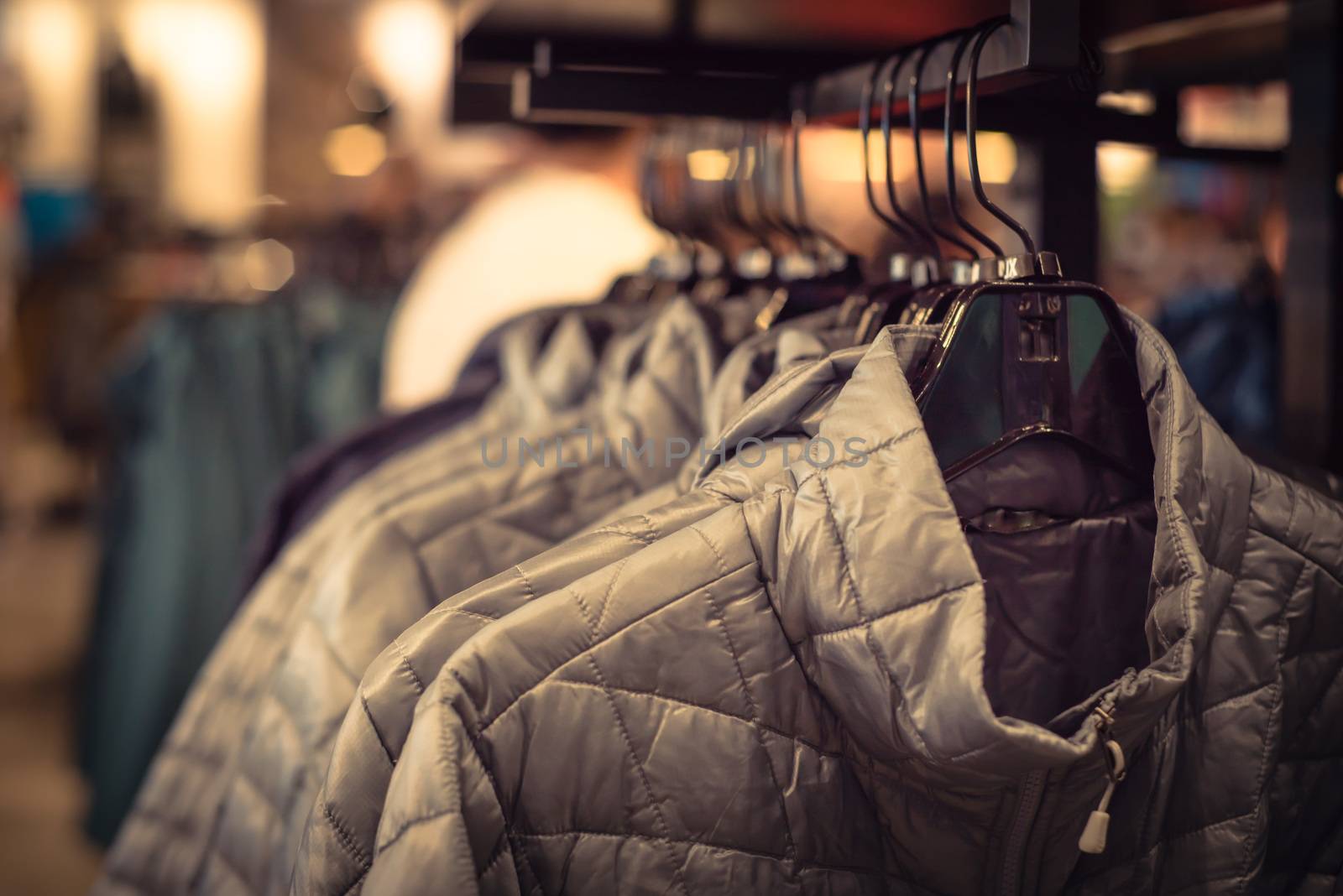 Filtered tone row of women down jackets at American outdoor clot by trongnguyen