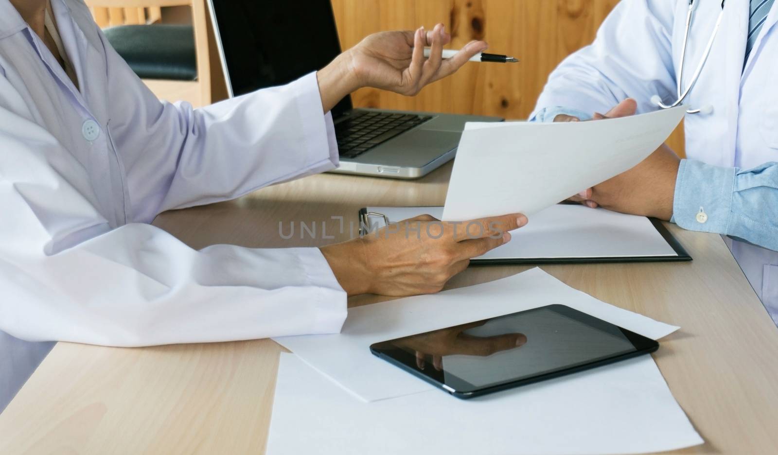 close up of patient and doctor taking notes or Professional medical doctor in white uniform gown coat interview.