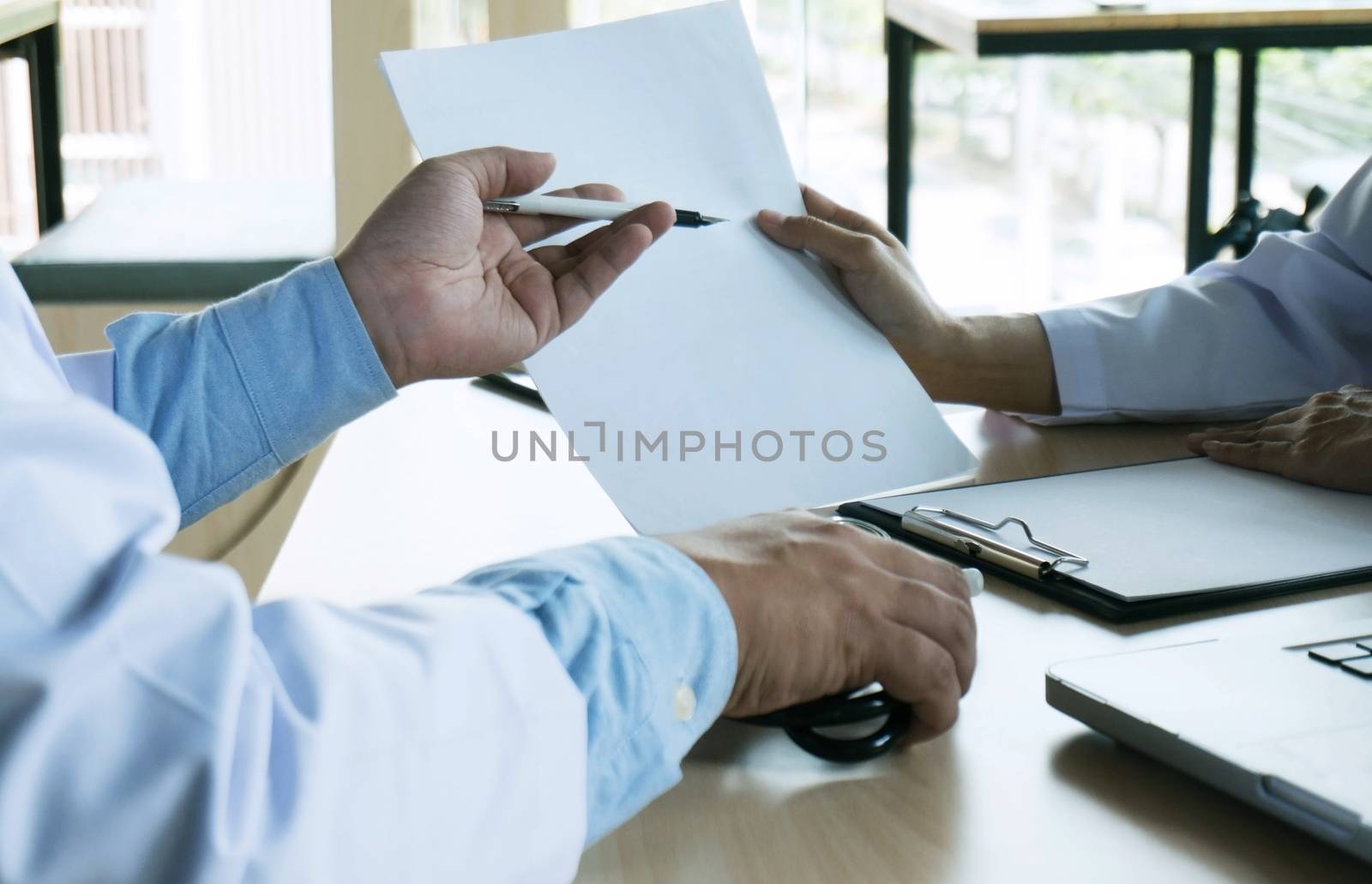 close up of patient and doctor taking notes or Professional medical doctor in white uniform gown coat interview.