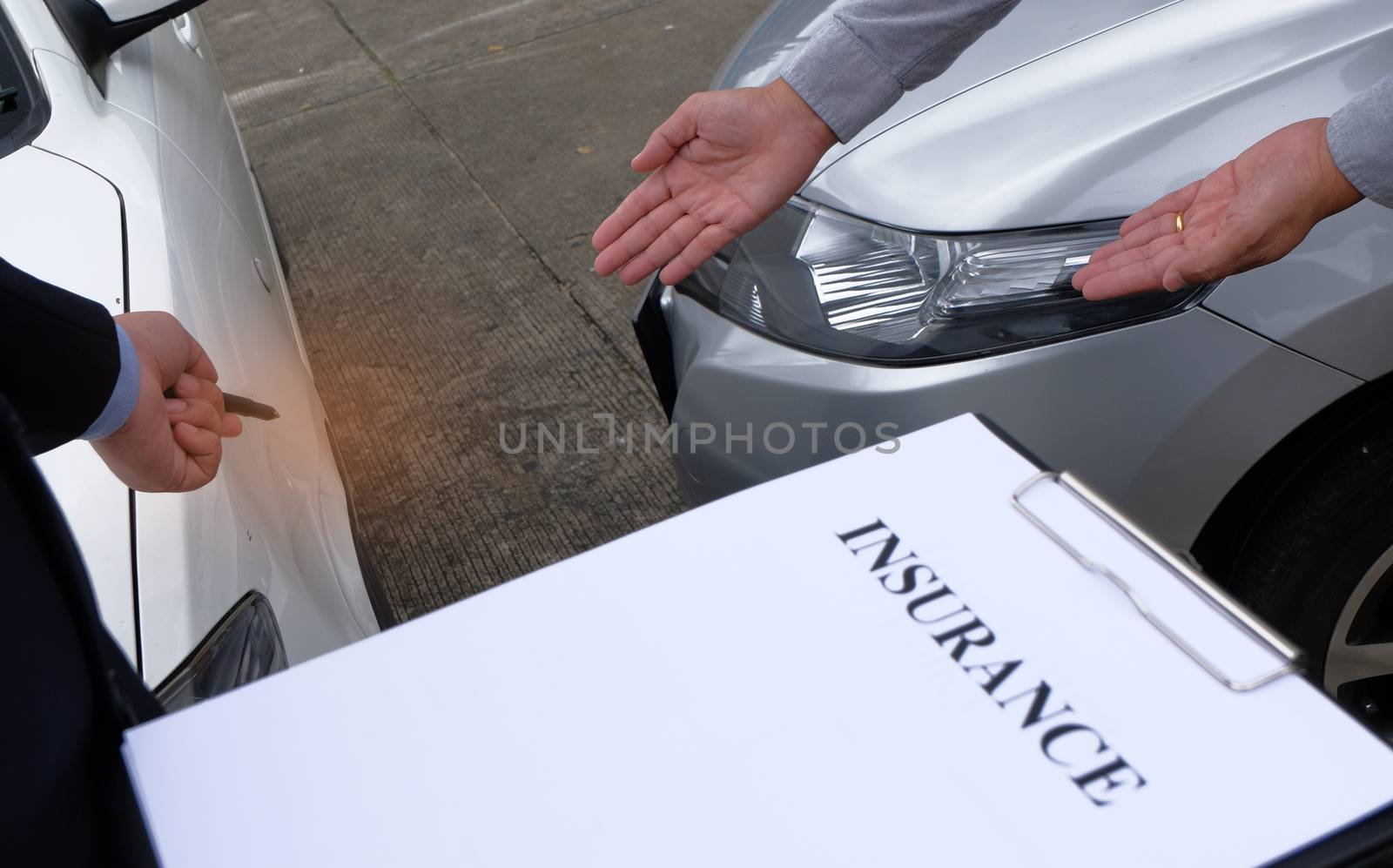 Loss Adjuster Insurance Agent Inspecting Damaged Car. by peandben