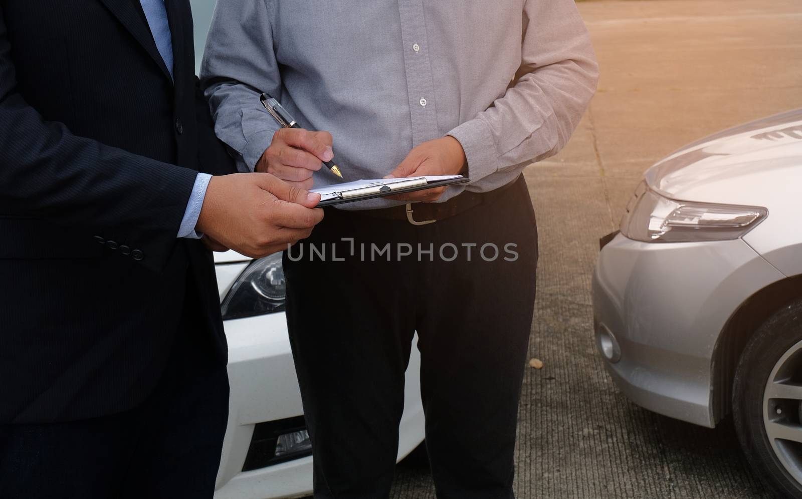 Loss Adjuster Insurance Agent Inspecting Damaged Car. by peandben