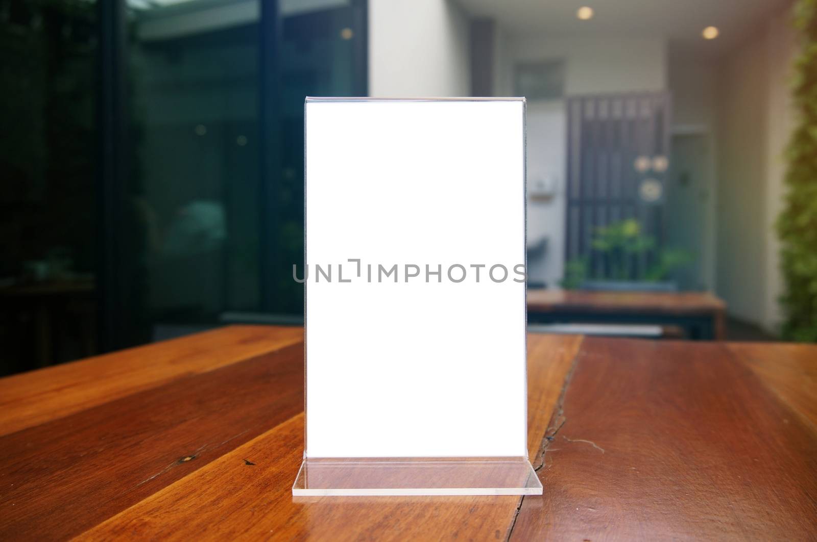 Mock up Menu frame standing on wood table in Bar restaurant cafe by peandben