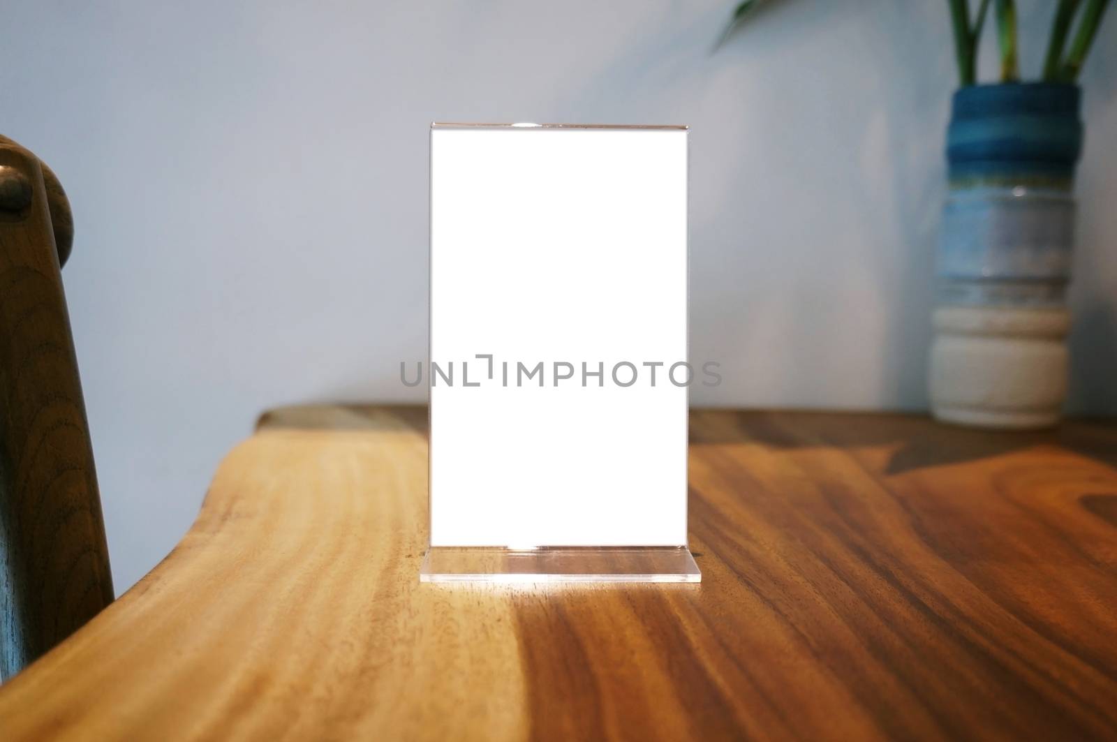 Mock up Menu frame standing on wood table in Bar restaurant cafe by peandben