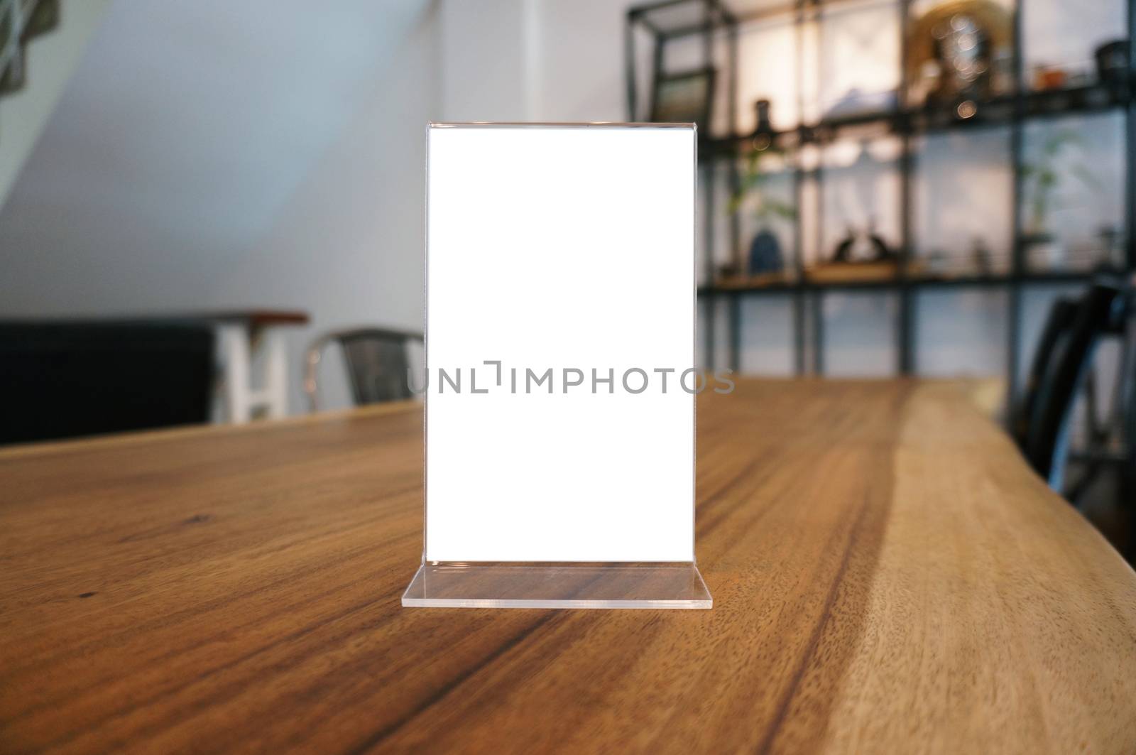 Mock up Menu frame standing on wood table in Bar restaurant cafe. space for text.