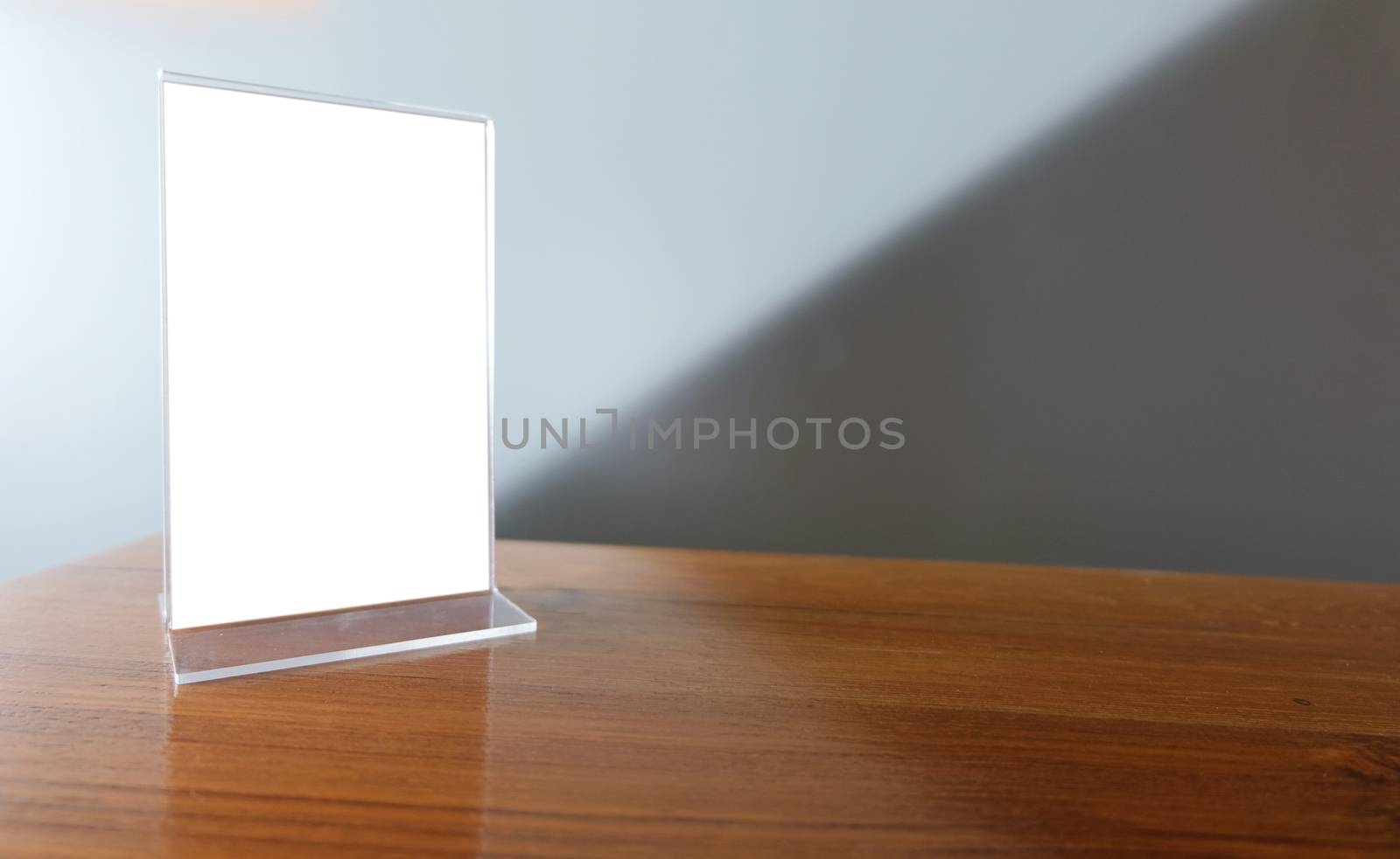 Mock up Menu frame standing on wood table in Bar restaurant cafe. space for text.