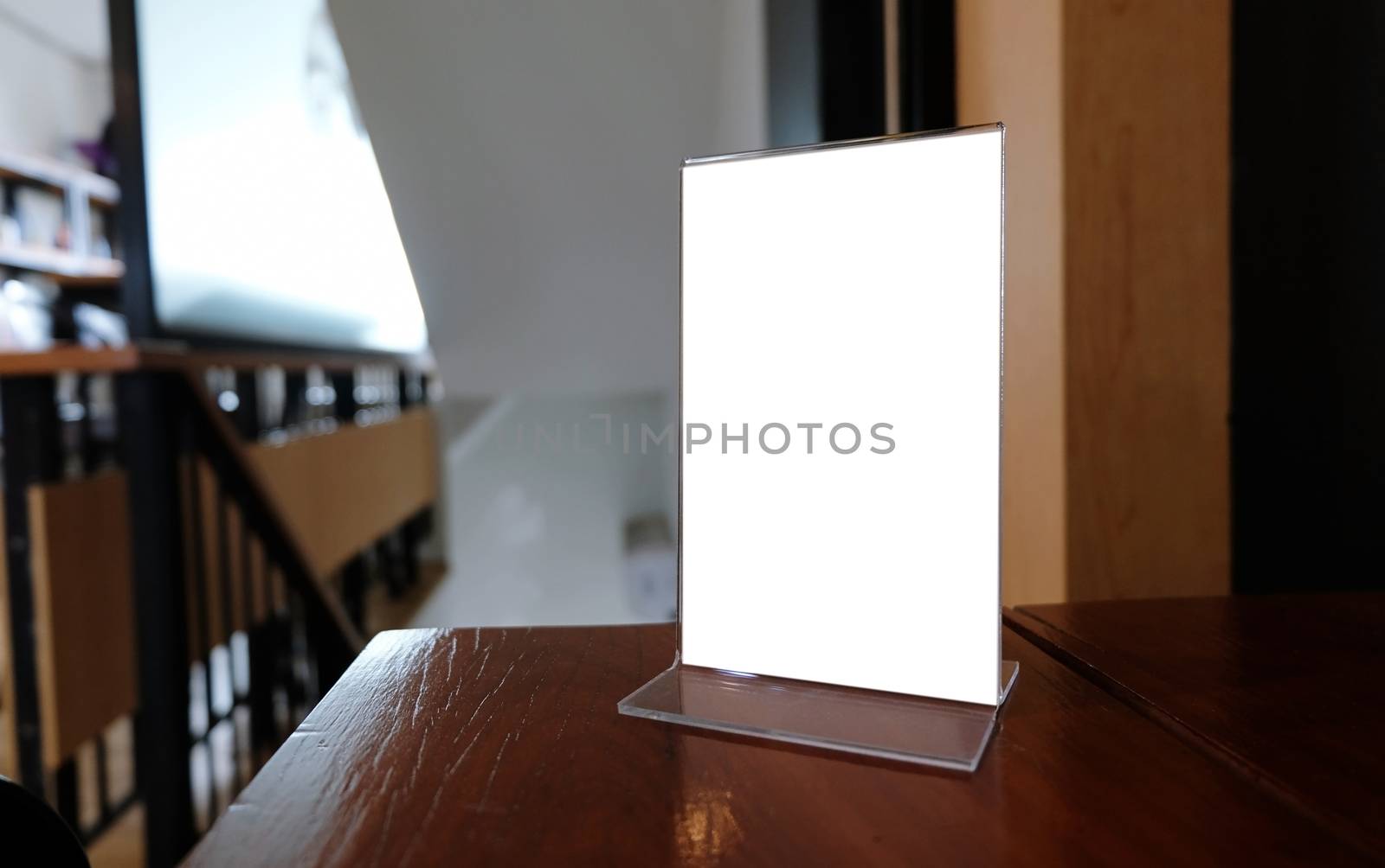 Mock up Menu frame standing on wood table in Bar restaurant cafe by peandben