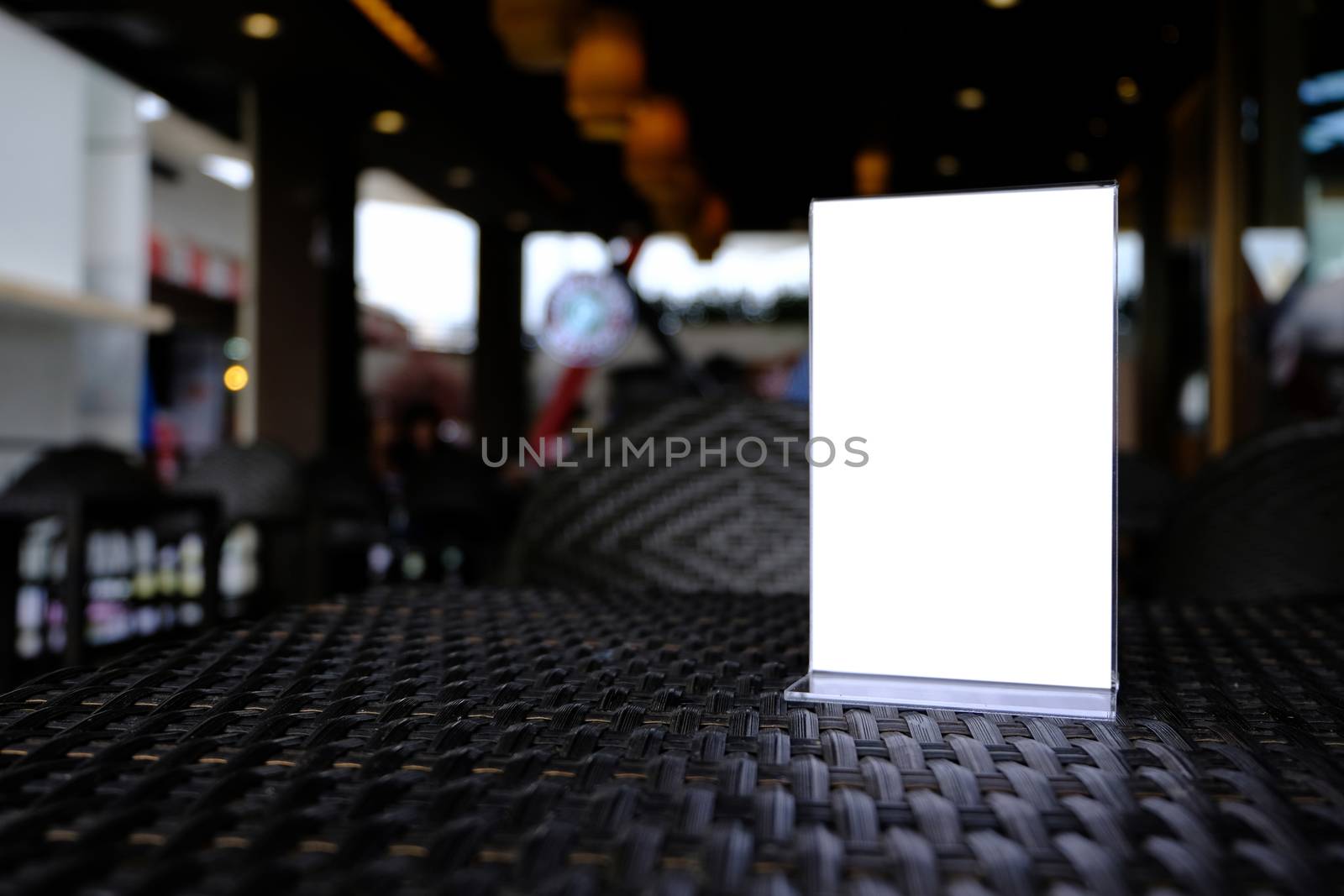 Mock up Menu frame standing on wood table in Bar restaurant cafe. space for text