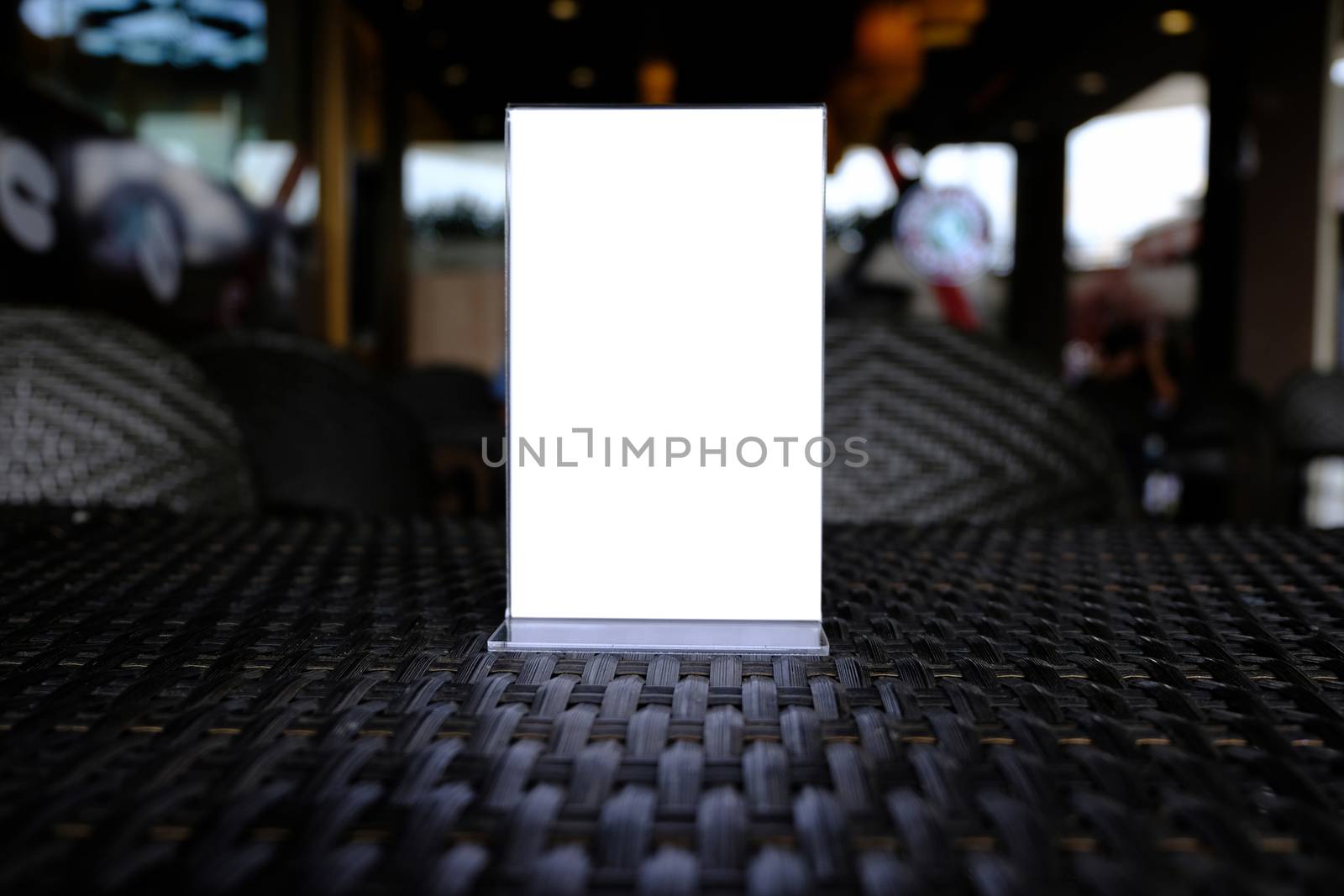 Mock up Menu frame standing on wood table in Bar restaurant cafe. space for text