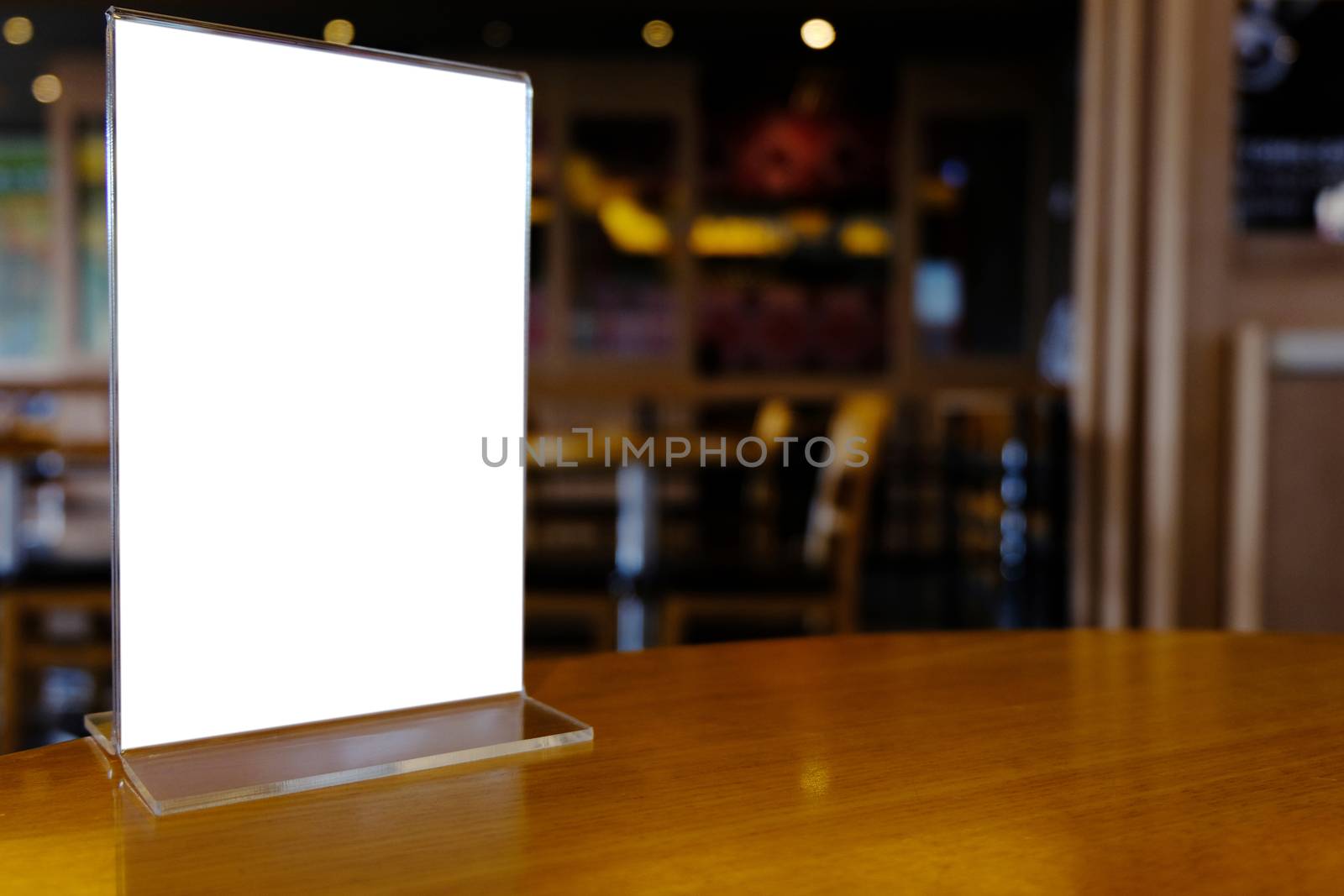 Mock up Menu frame standing on wood table in Bar restaurant cafe. space for text