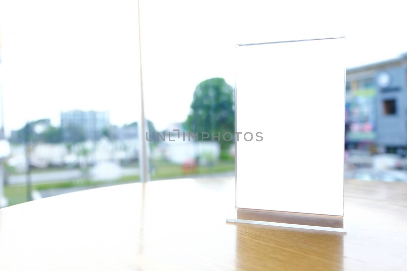 Mock up Menu frame standing on wood table in Bar restaurant cafe. space for text