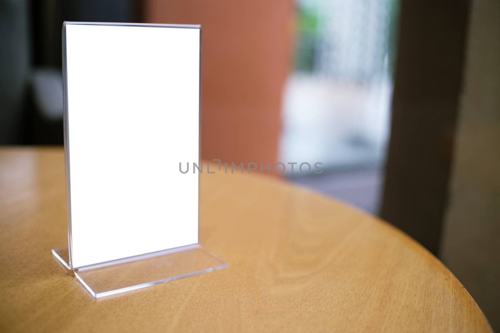 Mock up Menu frame standing on wood table in Bar restaurant cafe. space for text