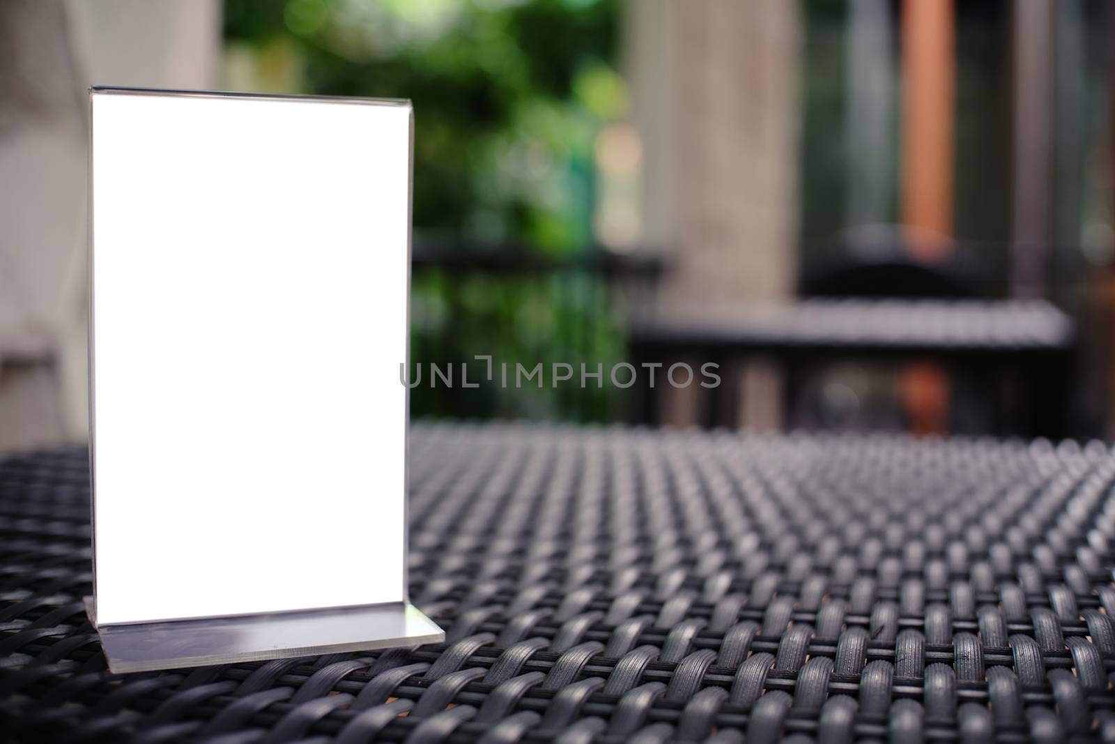 Mock up Menu frame standing on wood table in Bar restaurant cafe. space for text