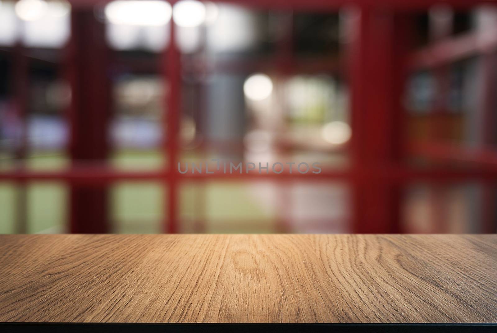 Empty dark wooden table in front of abstract blurred background  by peandben