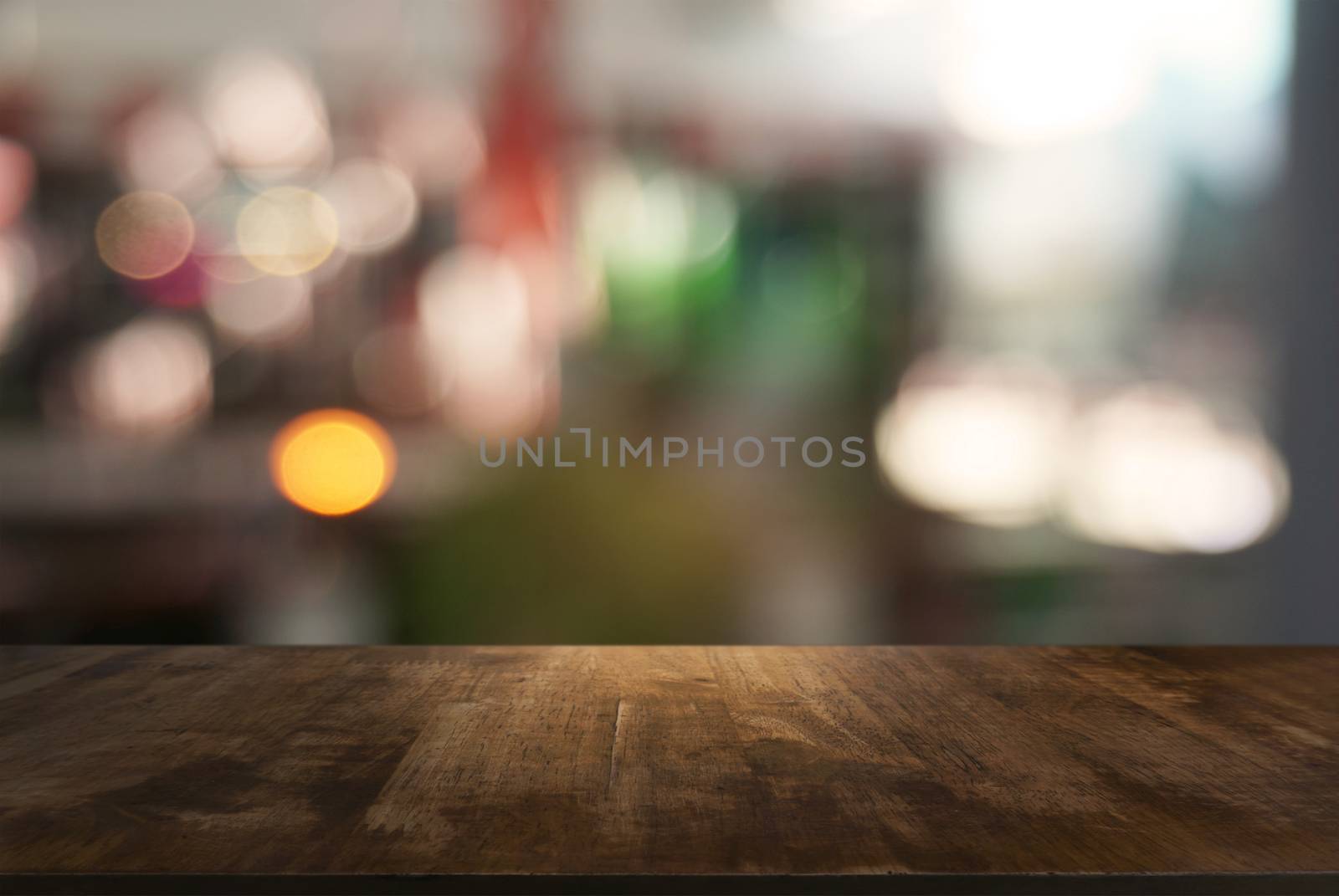 Empty dark wooden table in front of abstract blurred background of cafe and coffee shop interior. can be used for display or montage your products