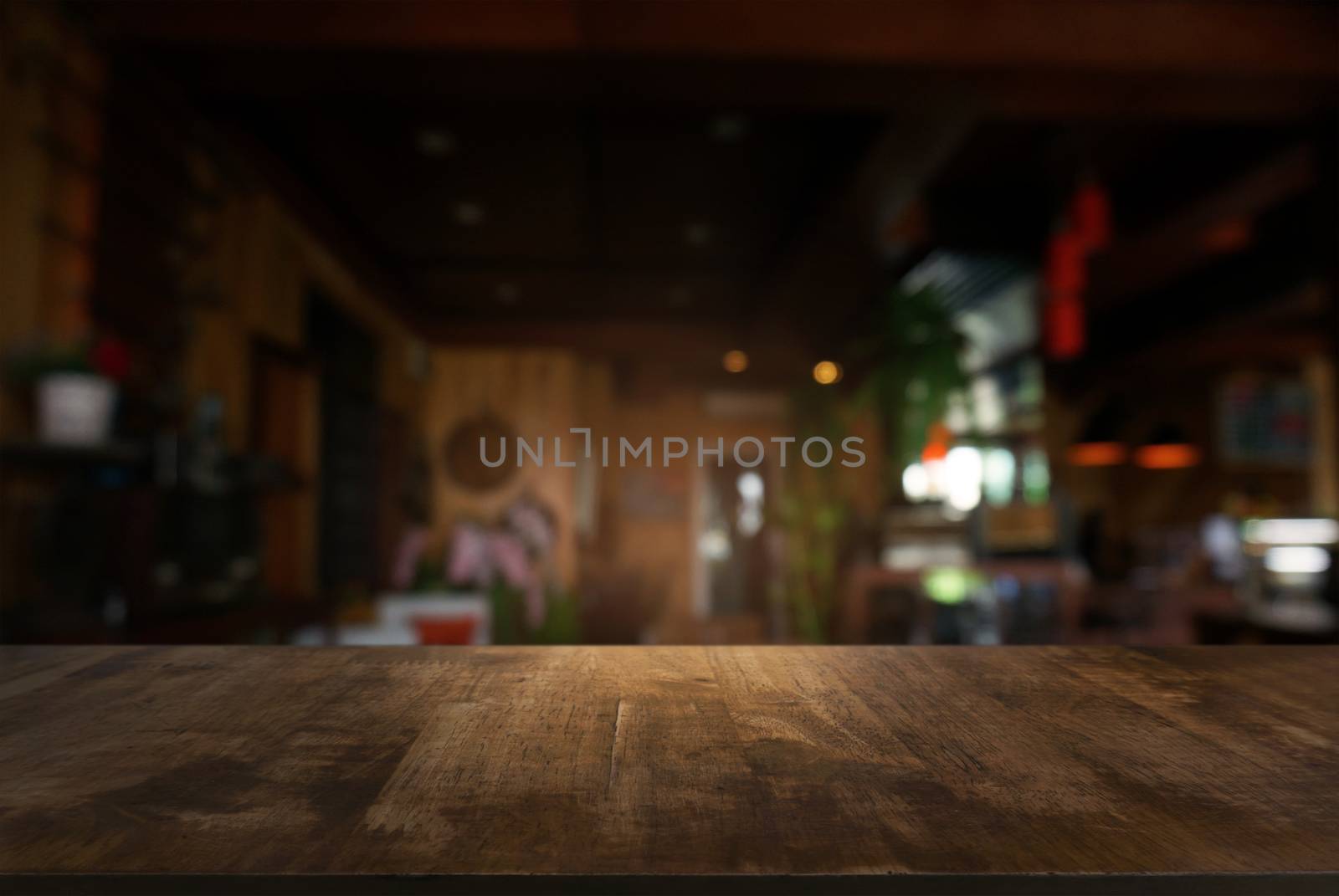 Empty dark wooden table in front of abstract blurred background  by peandben