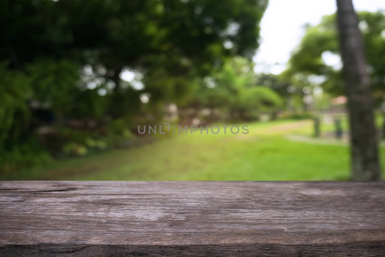 Empty wooden table in front of abstract blurred background of co by peandben