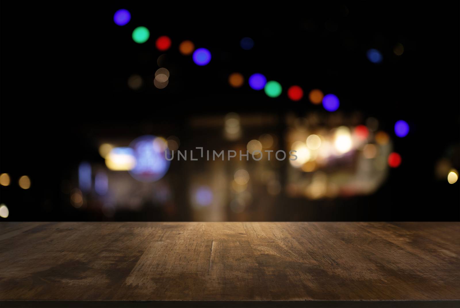 Empty of dark wooden table in front of abstract blurred background of bokeh light . can be used for display or montage your products.Mock up for display of product.
