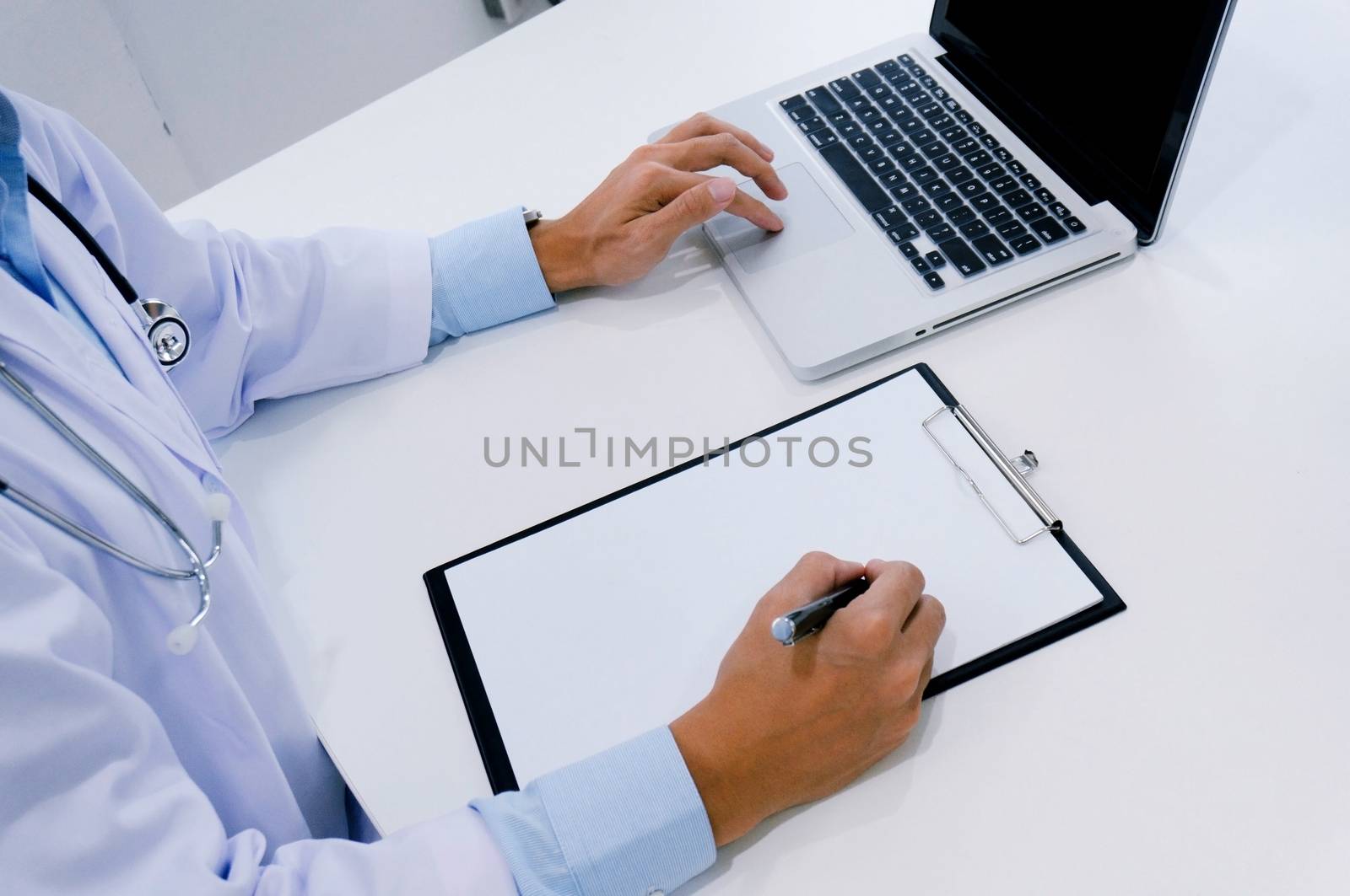 close up of patient and doctor taking notes or Professional medical doctor in white uniform gown coat interview