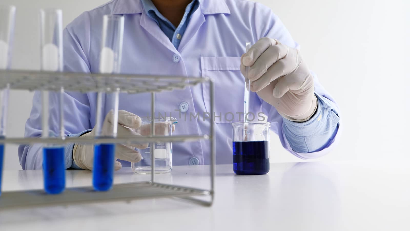 Male medical or scientific laboratory researcher performs tests  by peandben