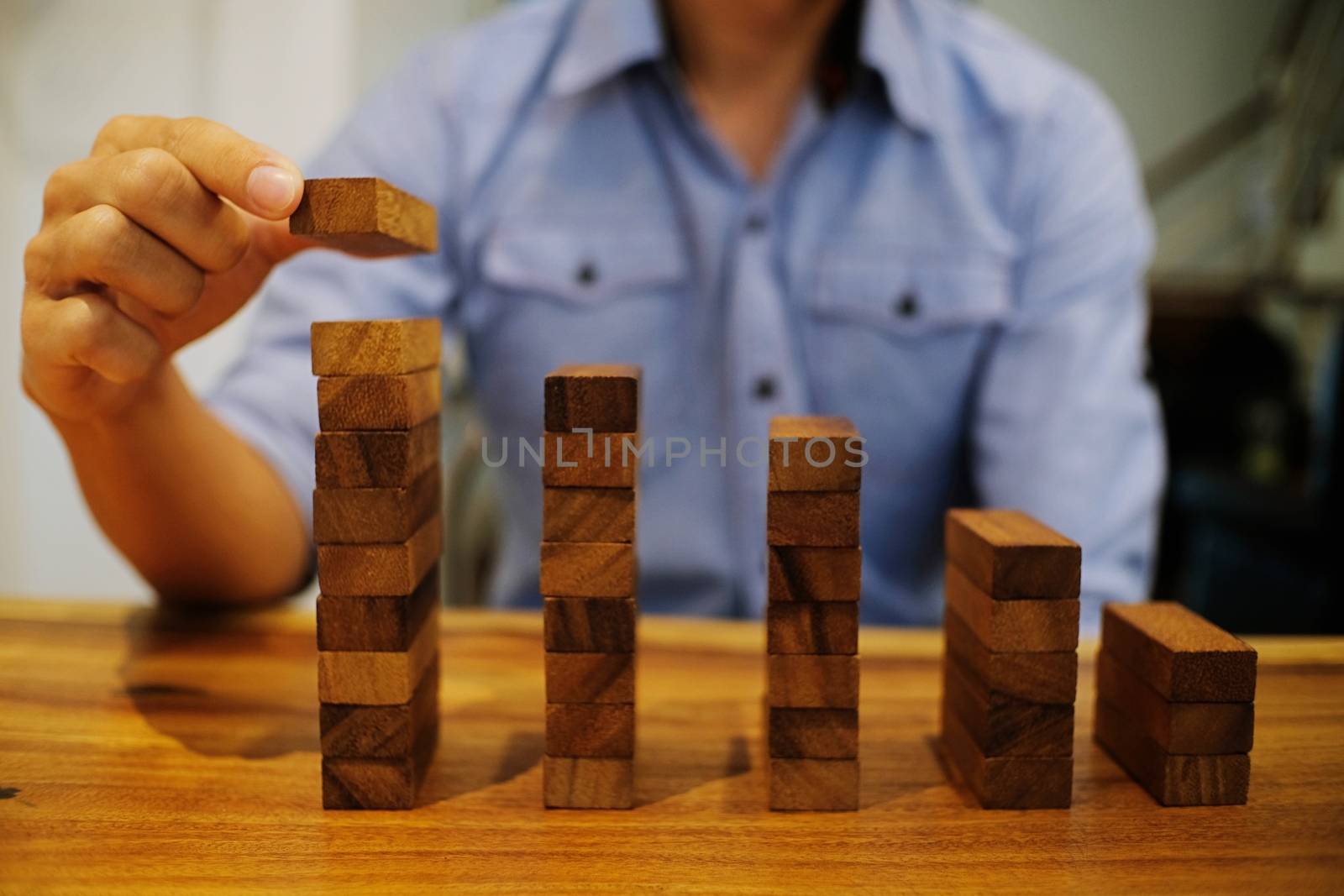 Planning risk and strategy in businessman gambling placing wooden block.Business concept for growth success process.