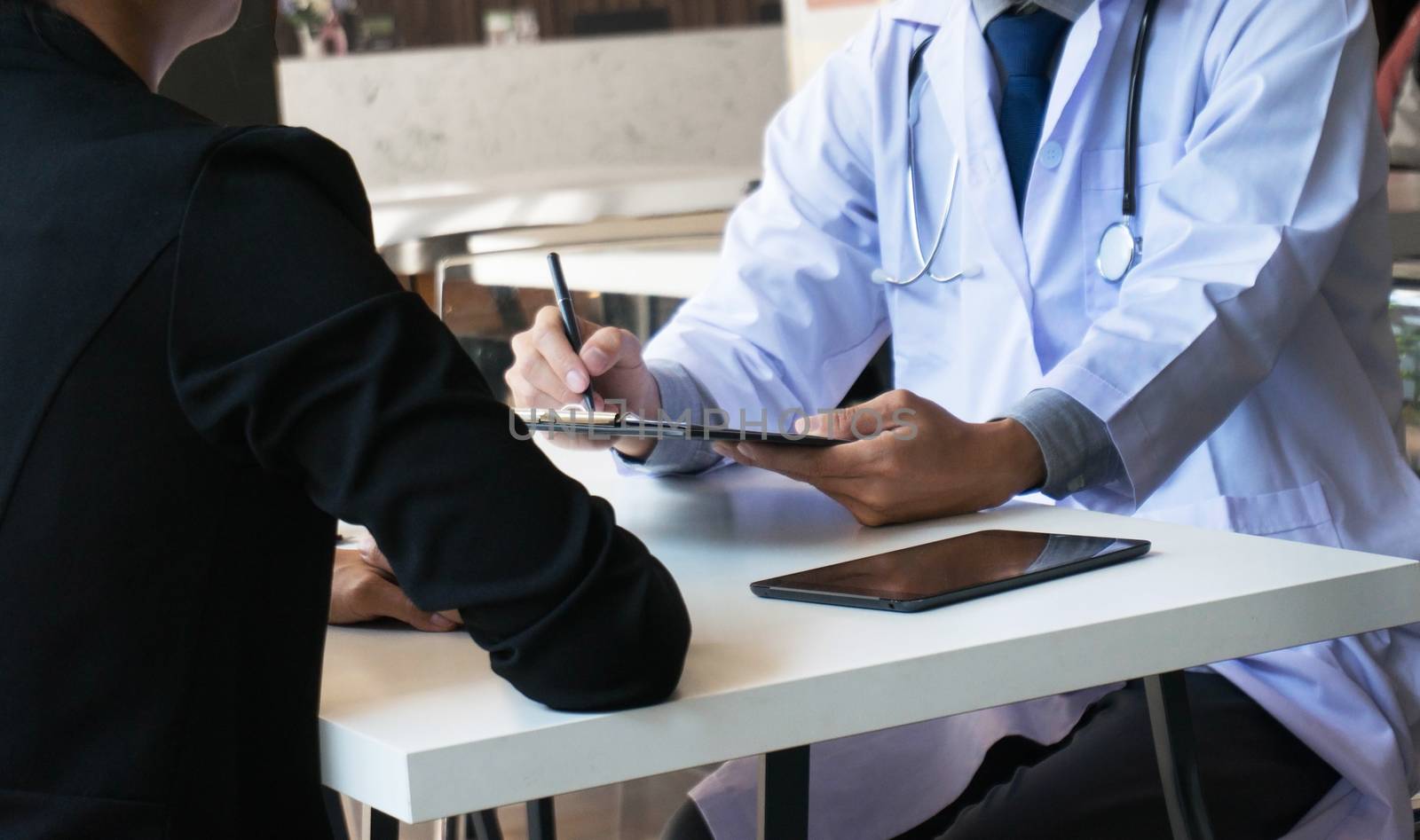 medicine doctor explain diagnosis to doctor team holding and showing clipboard exploring important document.