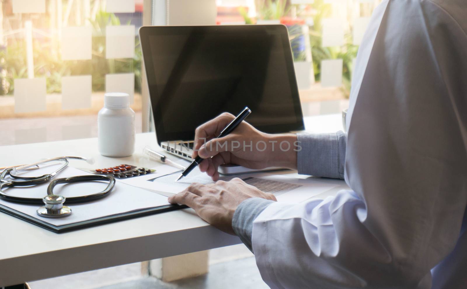 View of Details of doctor hands typing on keyboard with blank sc by peandben