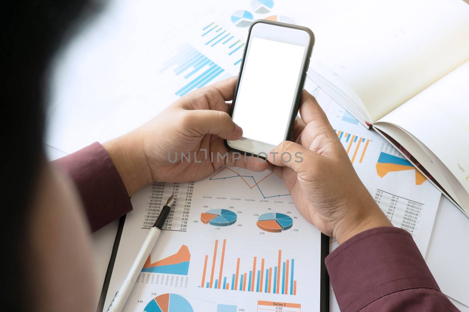 Business man using smartphone blank white screen.working at office with documents on his desk