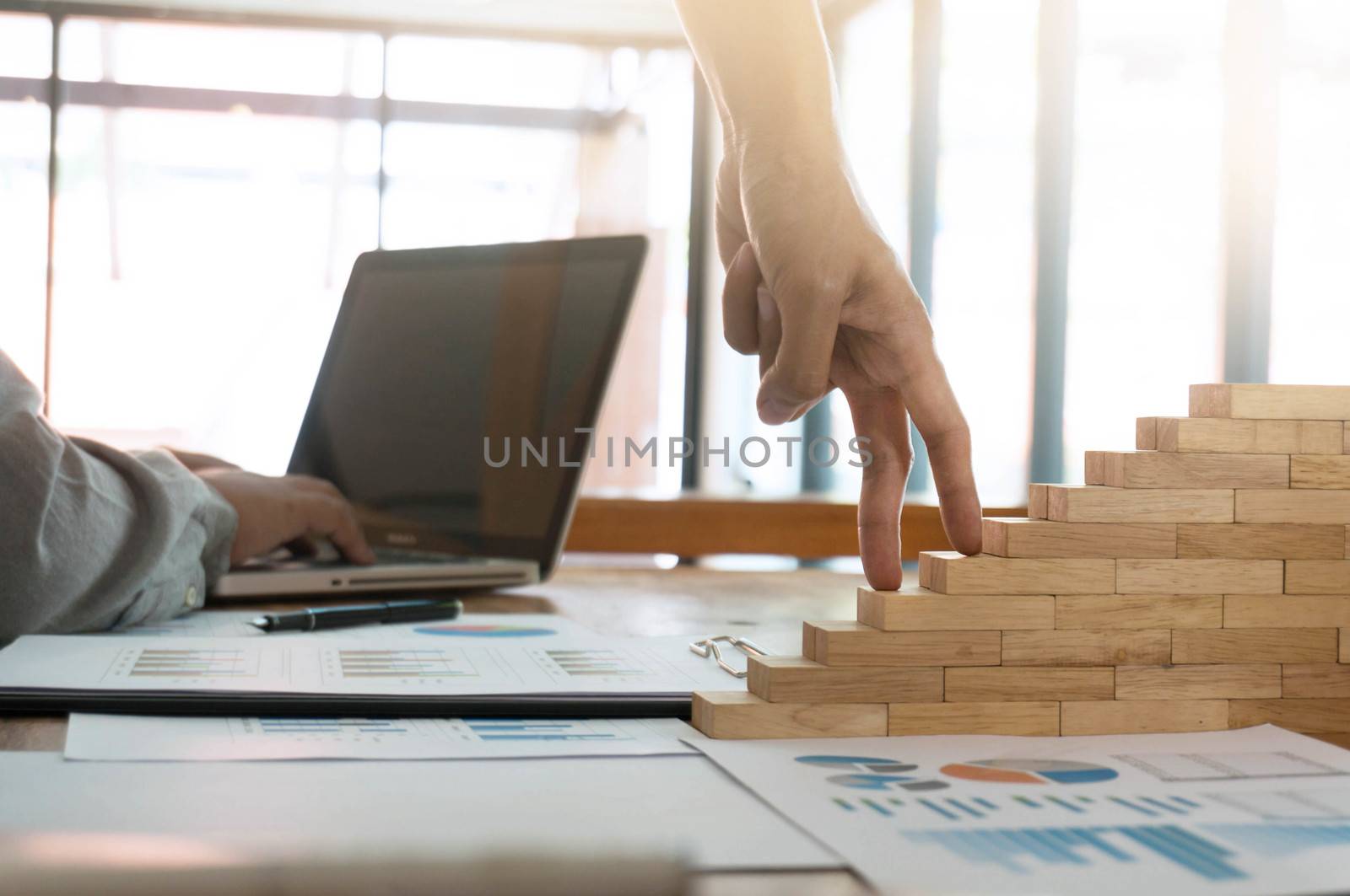 Success concept with business woman hand climbing wooden block stairs in  Business Concept.