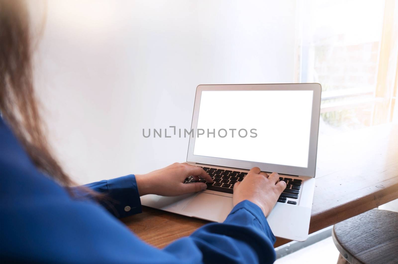 The Casual business woman works online on laptop which hand on keyboard in her house Isolated screen in laptop (blank white screen)