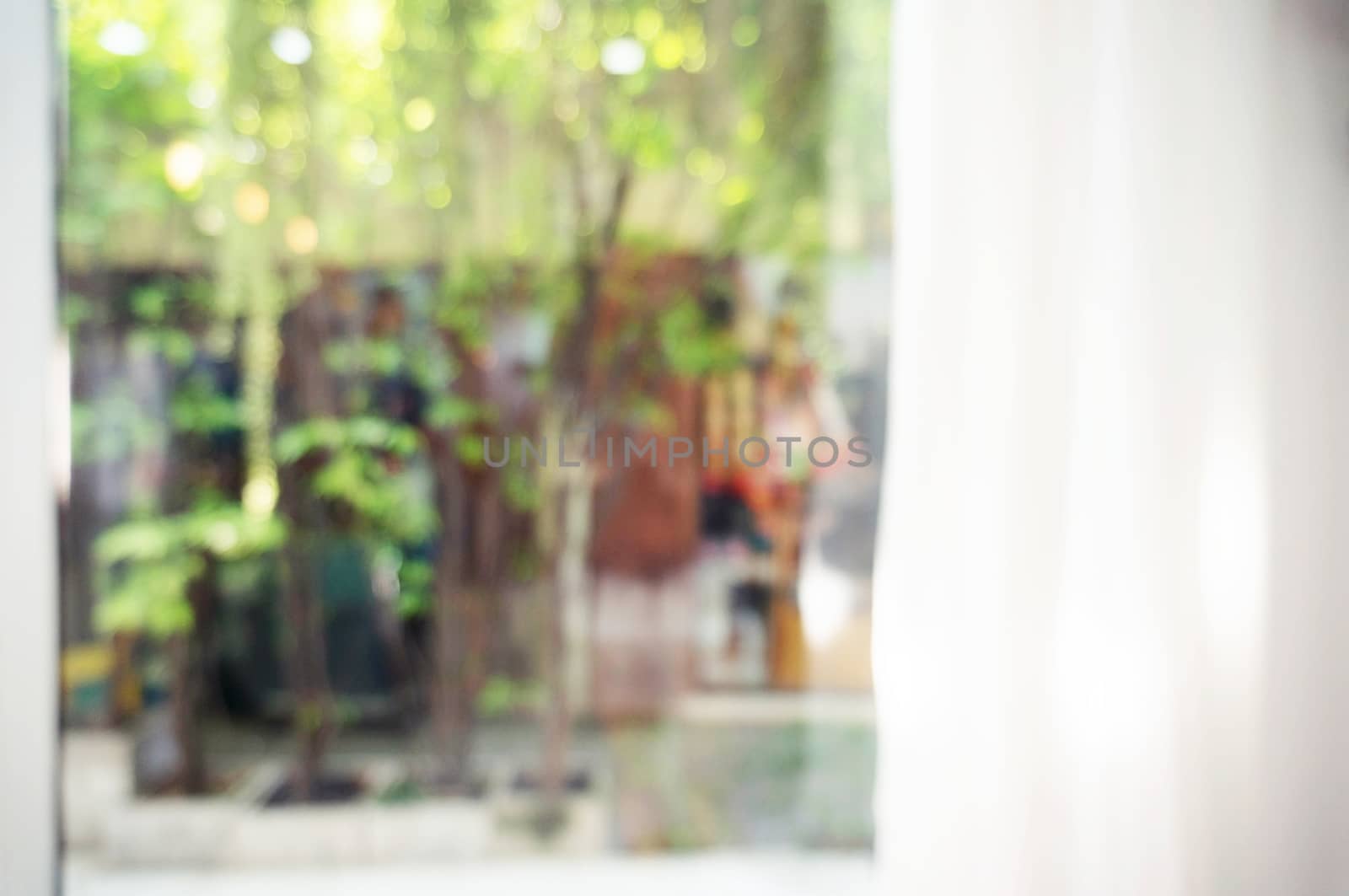 abstract blurred background of curtain with beautiful garden view. can be used for display or background image