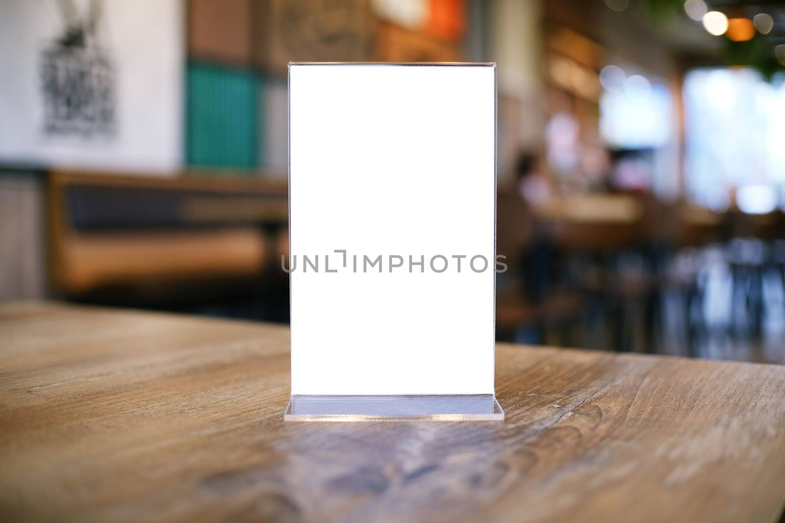 Mock up Menu frame standing on wood table in Bar restaurant cafe by peandben