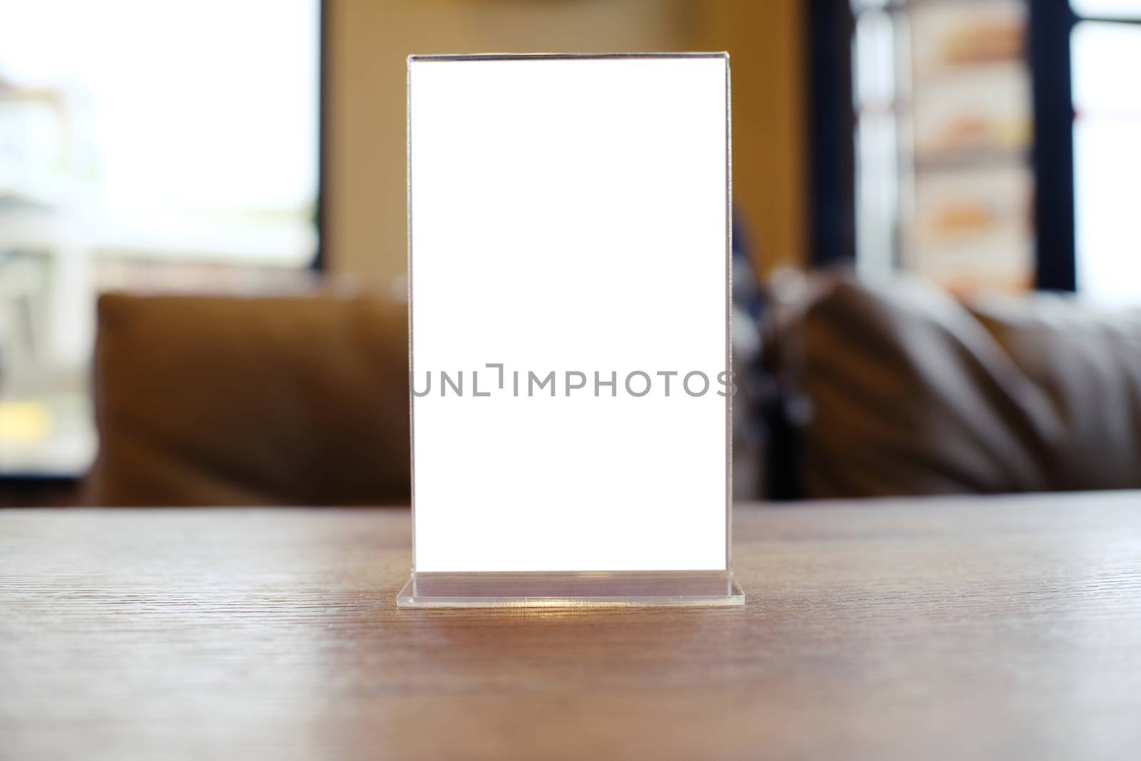 Mock up Menu frame standing on wood table in Bar restaurant cafe. space for text.