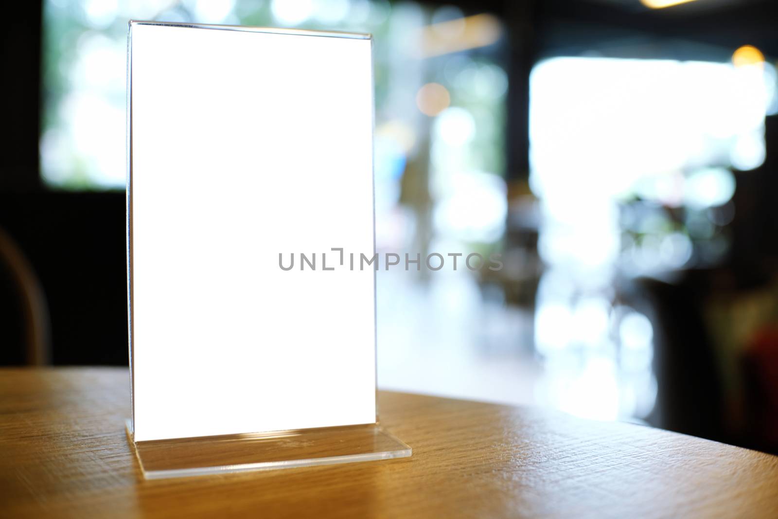 Mock up Menu frame standing on wood table in Bar restaurant cafe by peandben