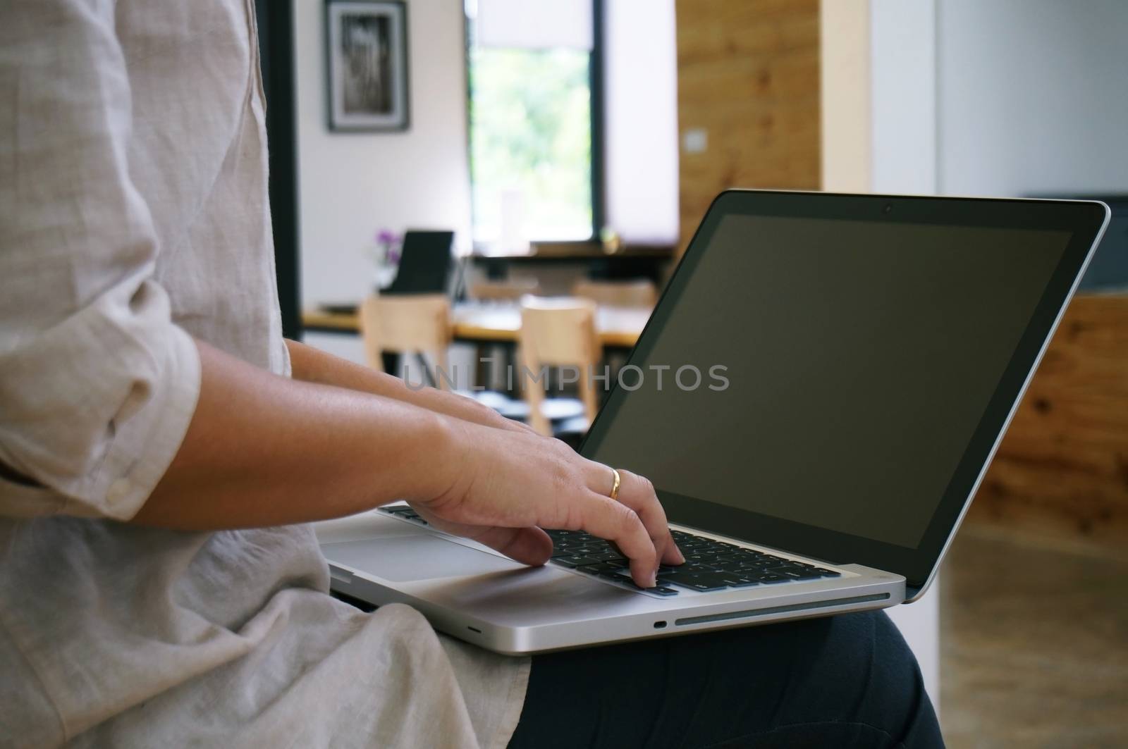 The Casual business woman works online on laptop which hand on keyboard in her house Isolated screen in laptop