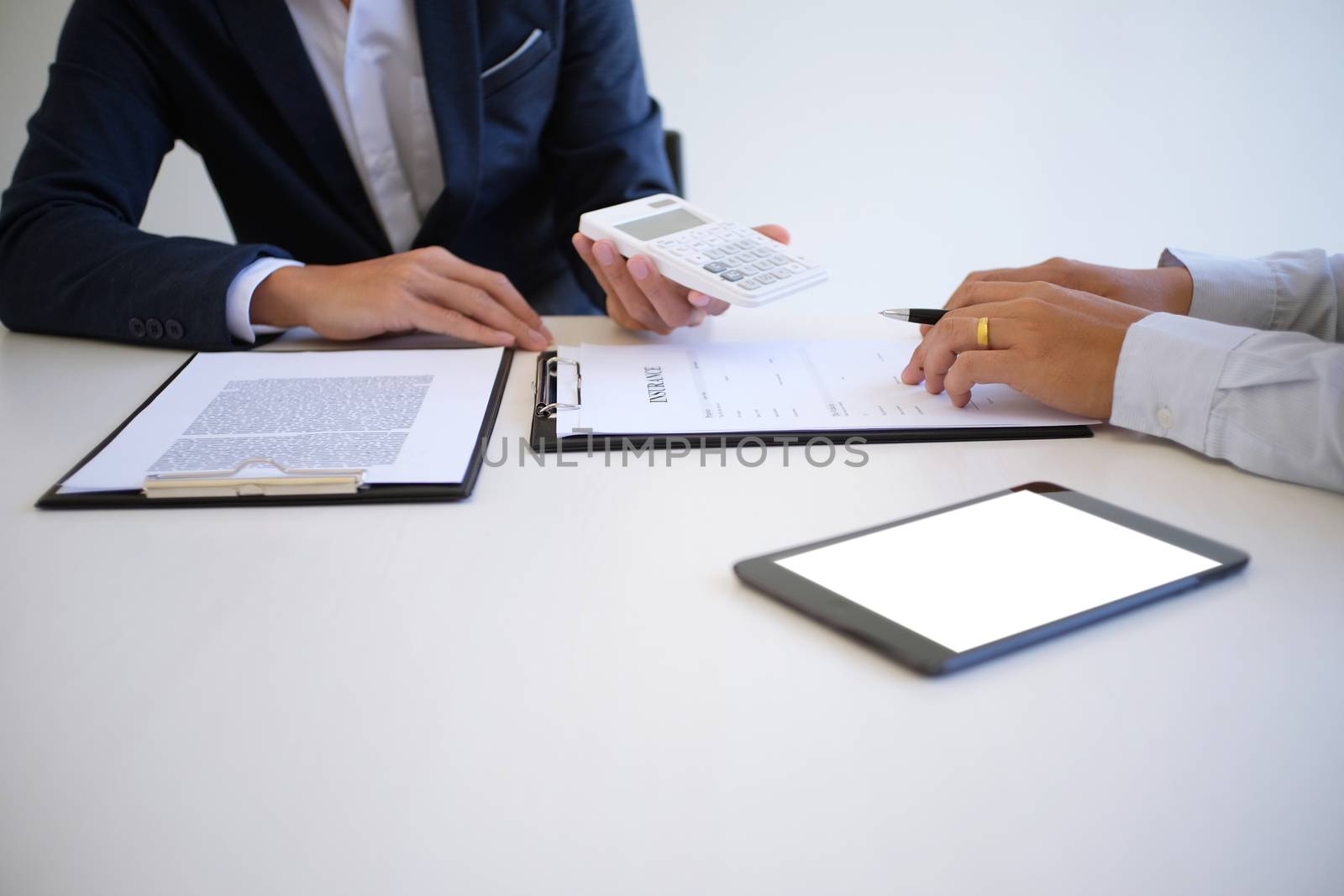 Sales manager giving advice application form document, considering mortgage loan offer for car and house insurance