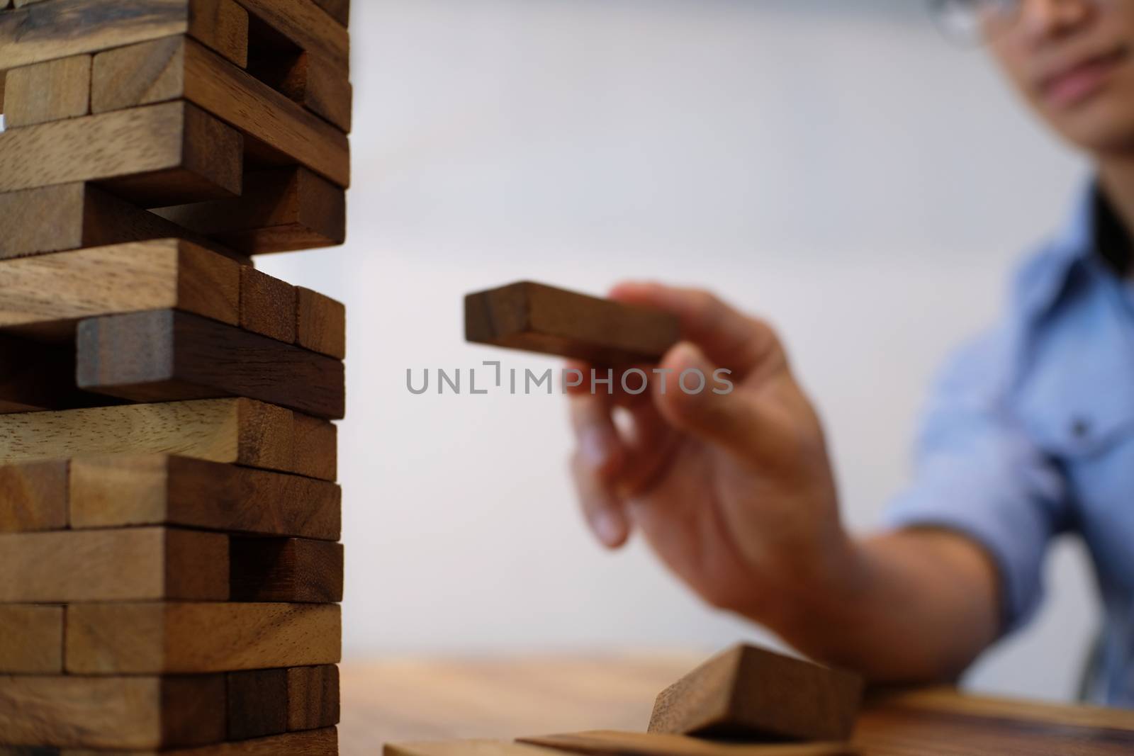 Group of Friends playing blocks wood game on the table folded puzzle