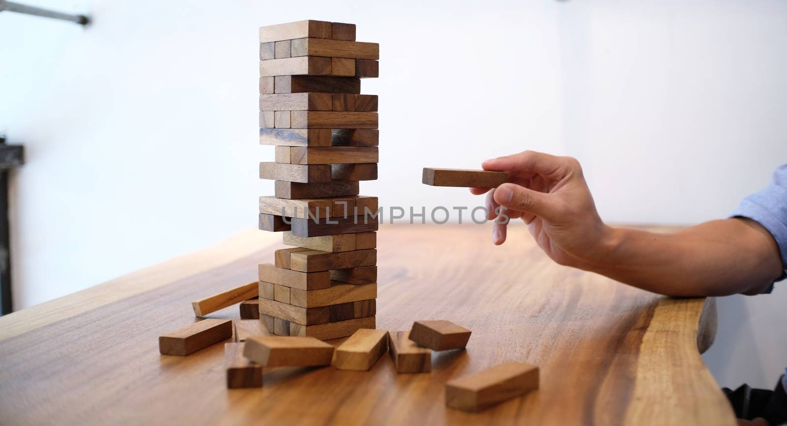 Group of Friends playing blocks wood game on the table folded pu by peandben