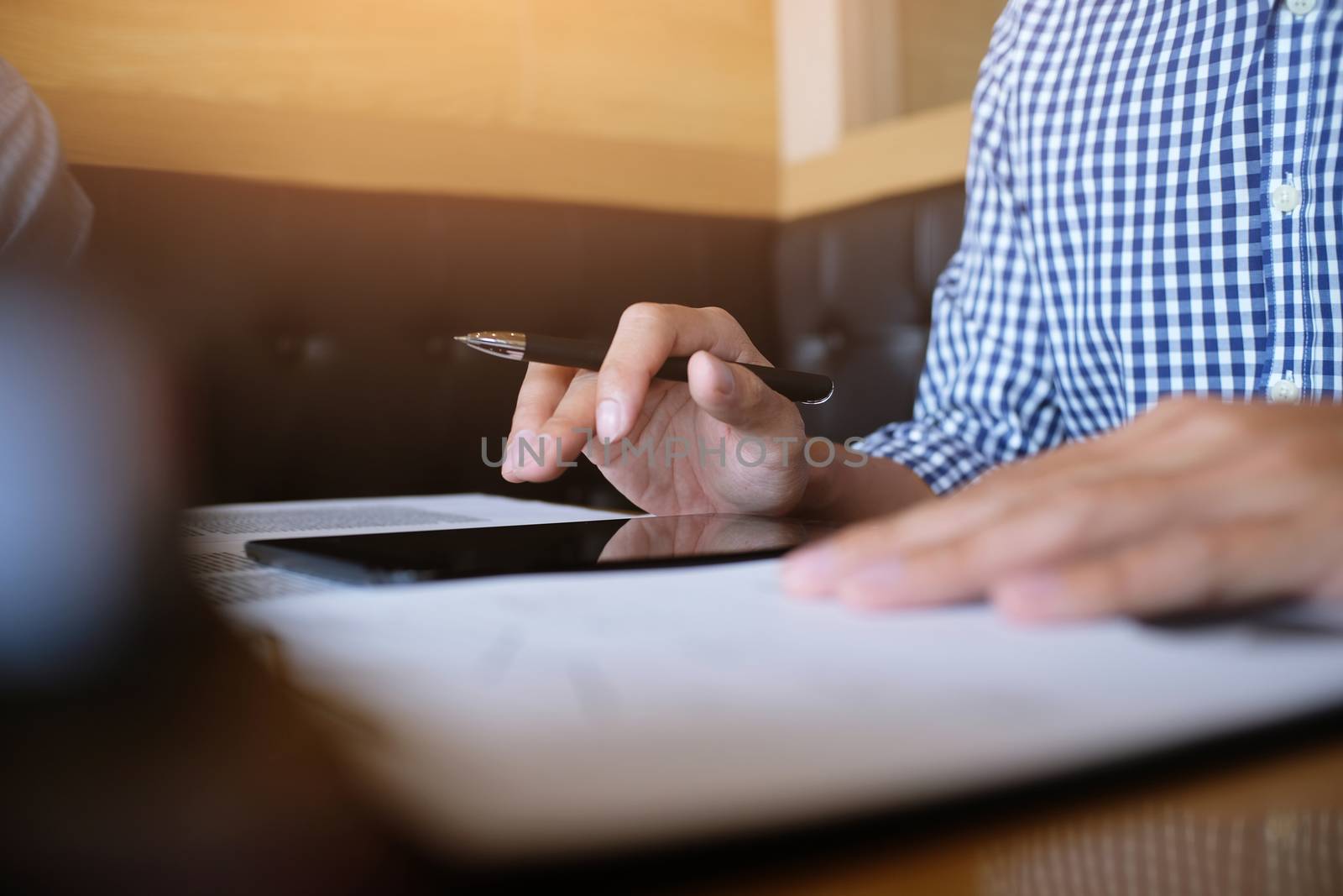 Man student writes information from portable tablet while prepar by peandben