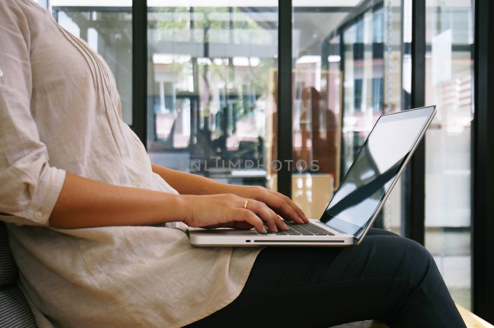 The Casual business woman works online on laptop which hand on keyboard in her house Isolated screen in laptop