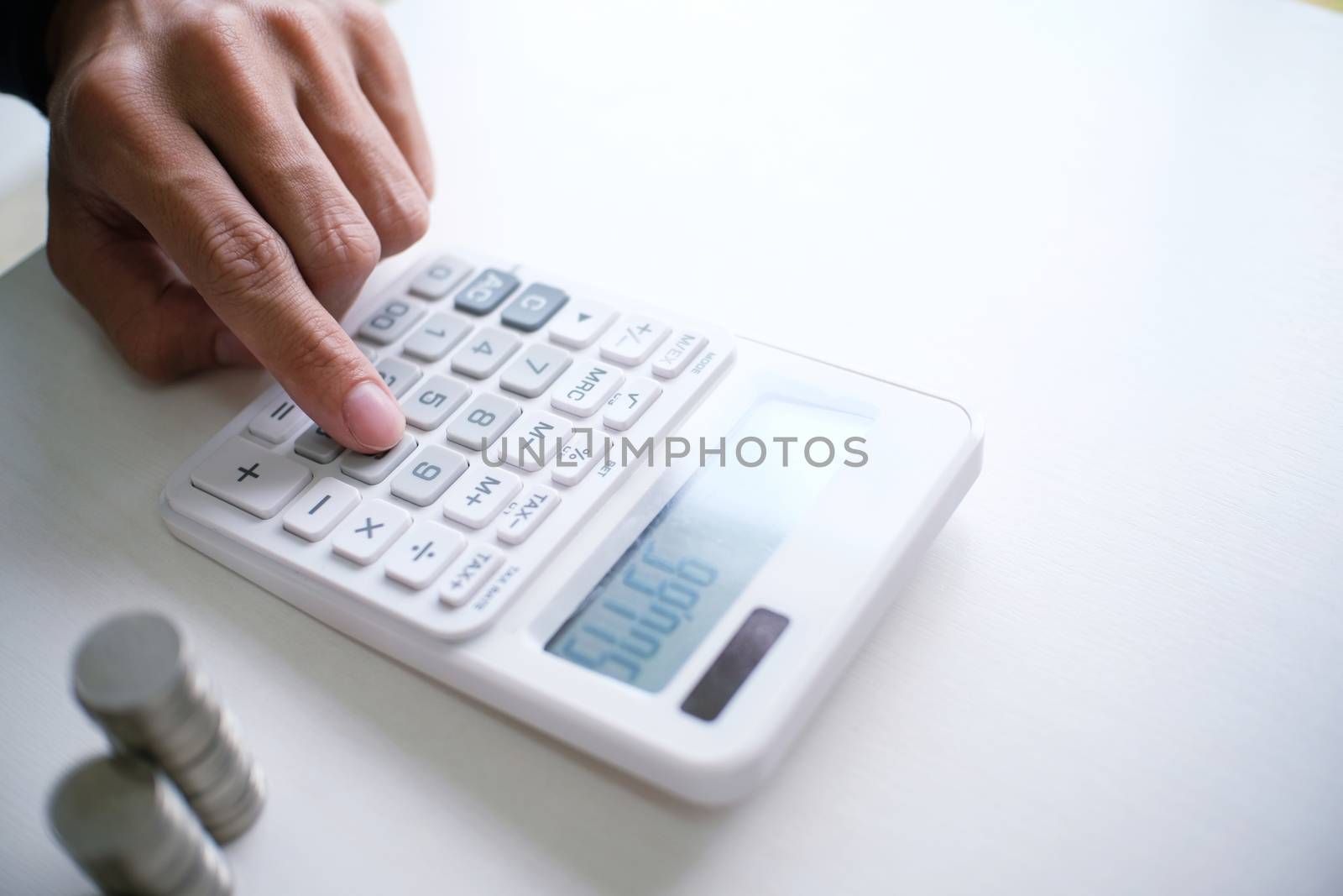 Accountant verify the business and saving money stacking gold coins with calculator. Accountancy Concept.