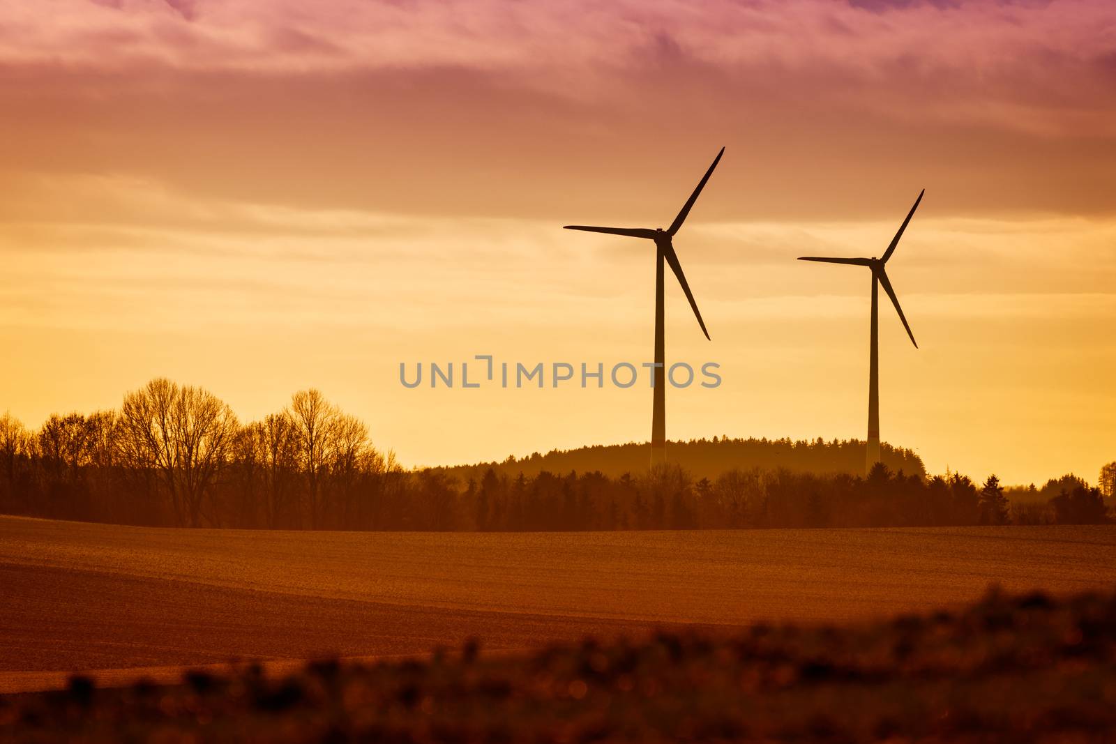Power Windmills with fields and trees in Bavaria, Germany