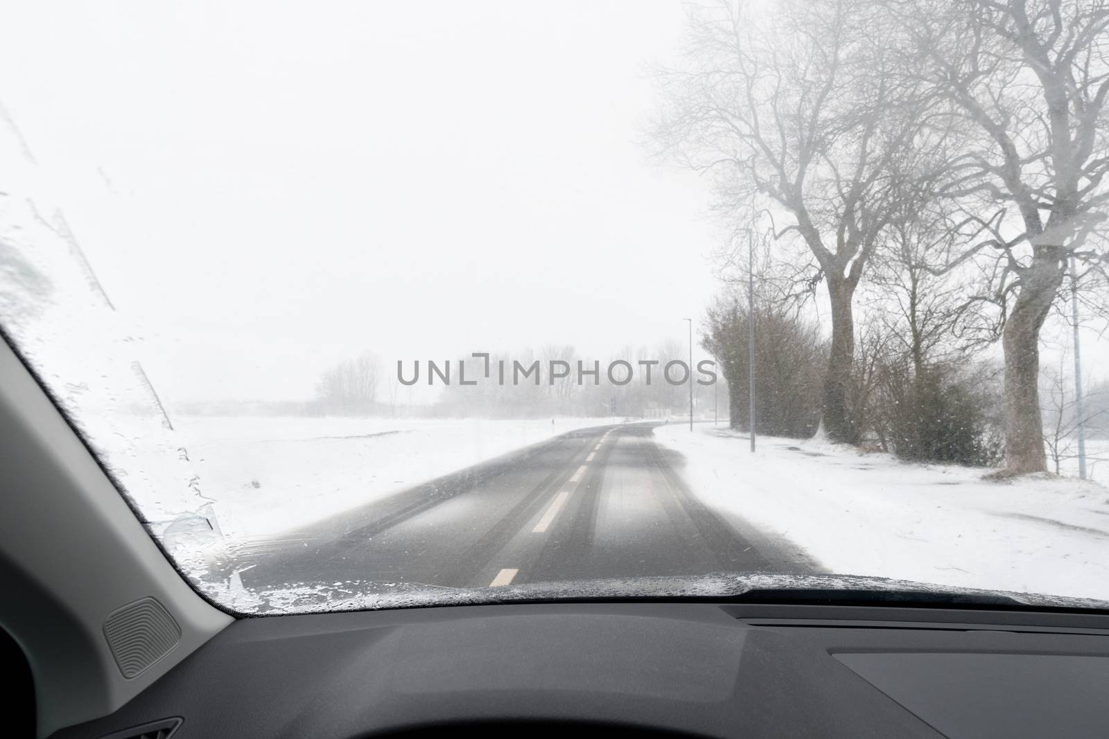 View from a car to road with snow in Winter