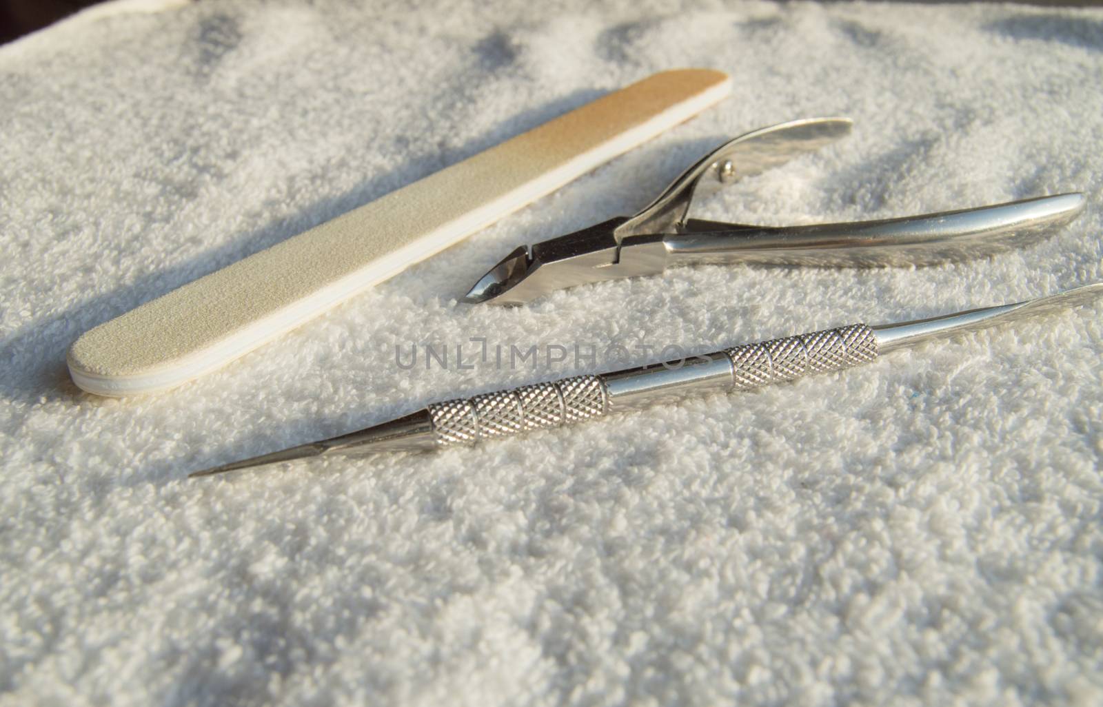 Tools of a manicure set on white background, concept of care of nails and cuticles.