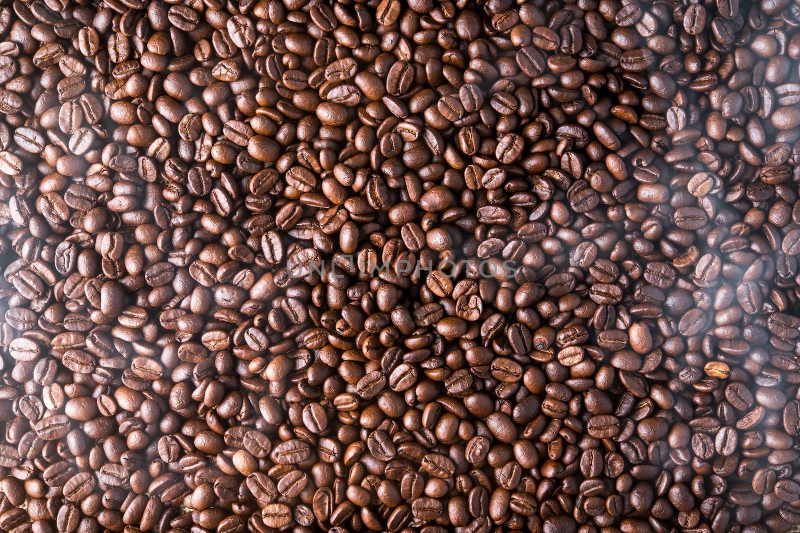 top view of roasted coffee beans background with smoke