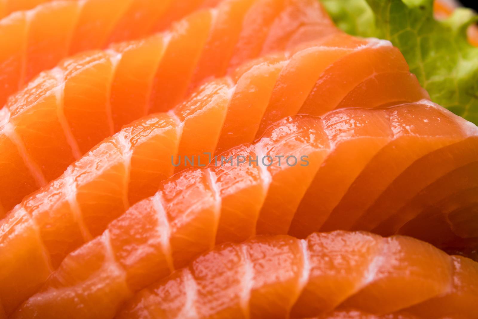 sliced salmon sashimi close up by antpkr