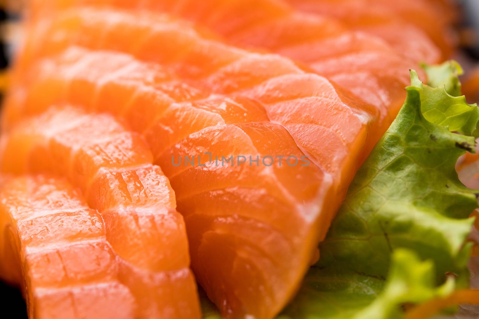 sliced salmon sashimi close up by antpkr