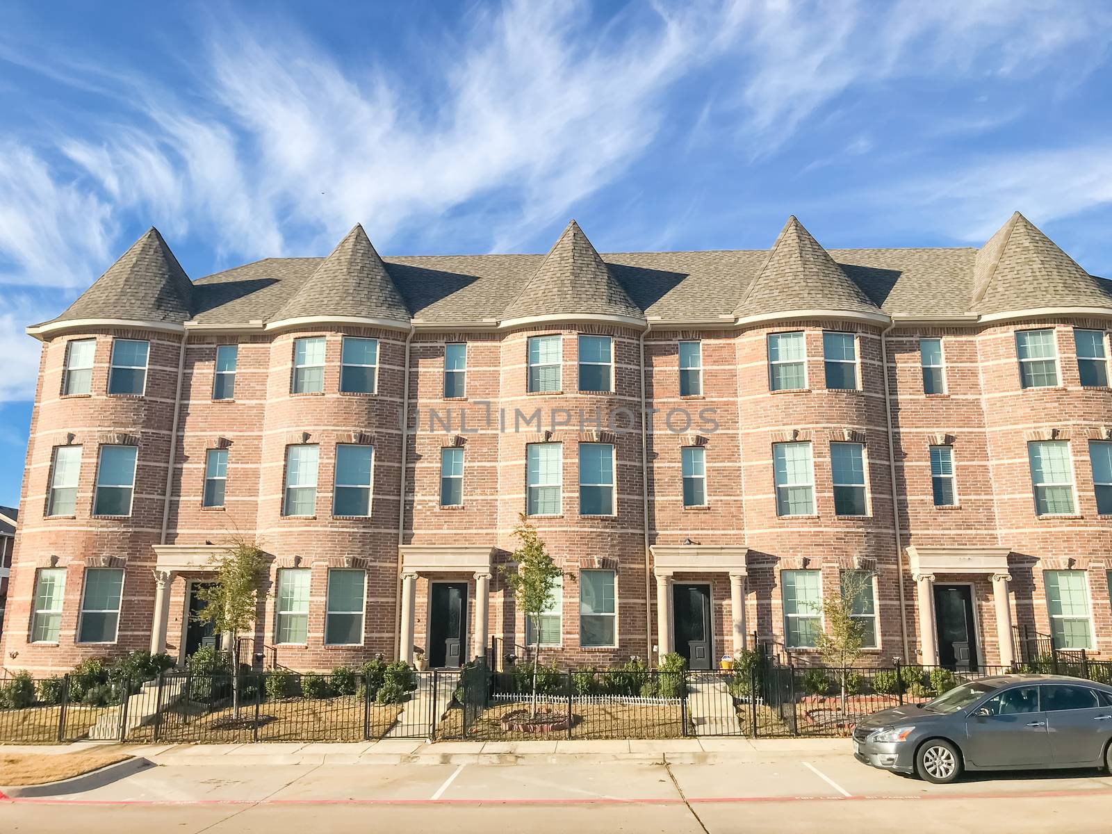 New townhome apartment complex with cars park on street near Dallas, Texas, USA